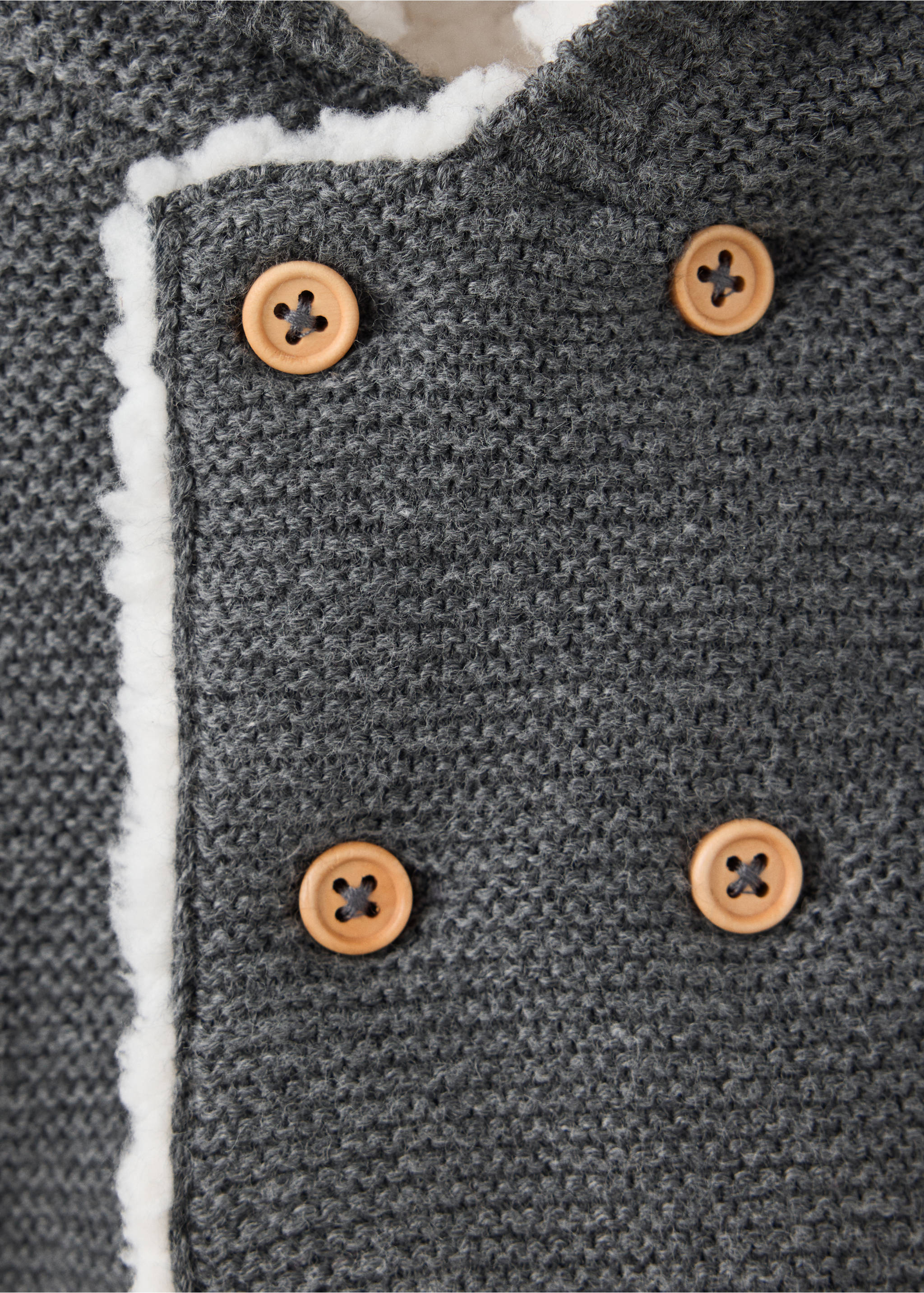 Grey knit cardigan detail with double-breasted wooden buttons and white faux-shearling lining., Charcoal. Ref: 37076354-00.