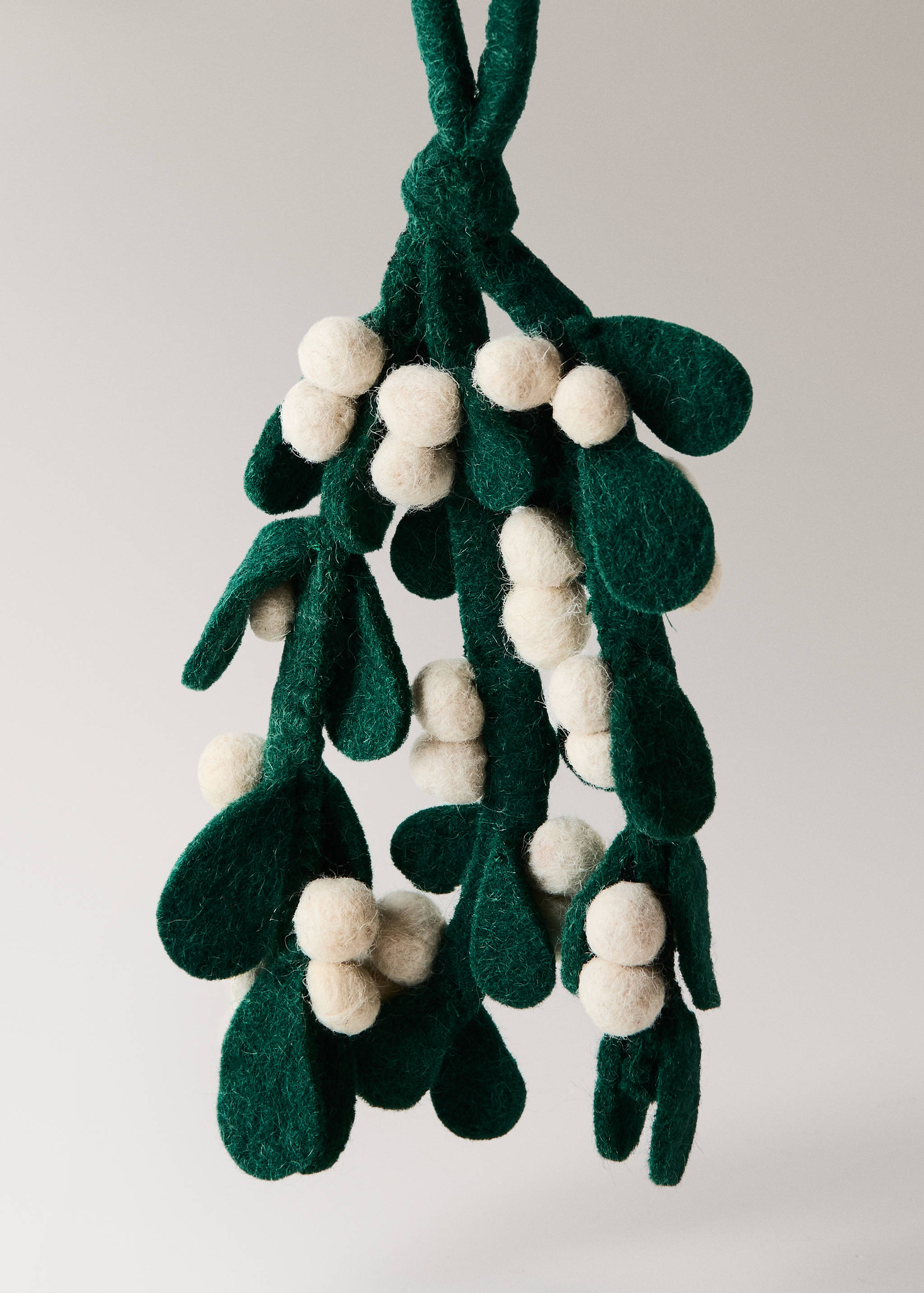 Dark green felt mistletoe decoration with off-white felt berries.