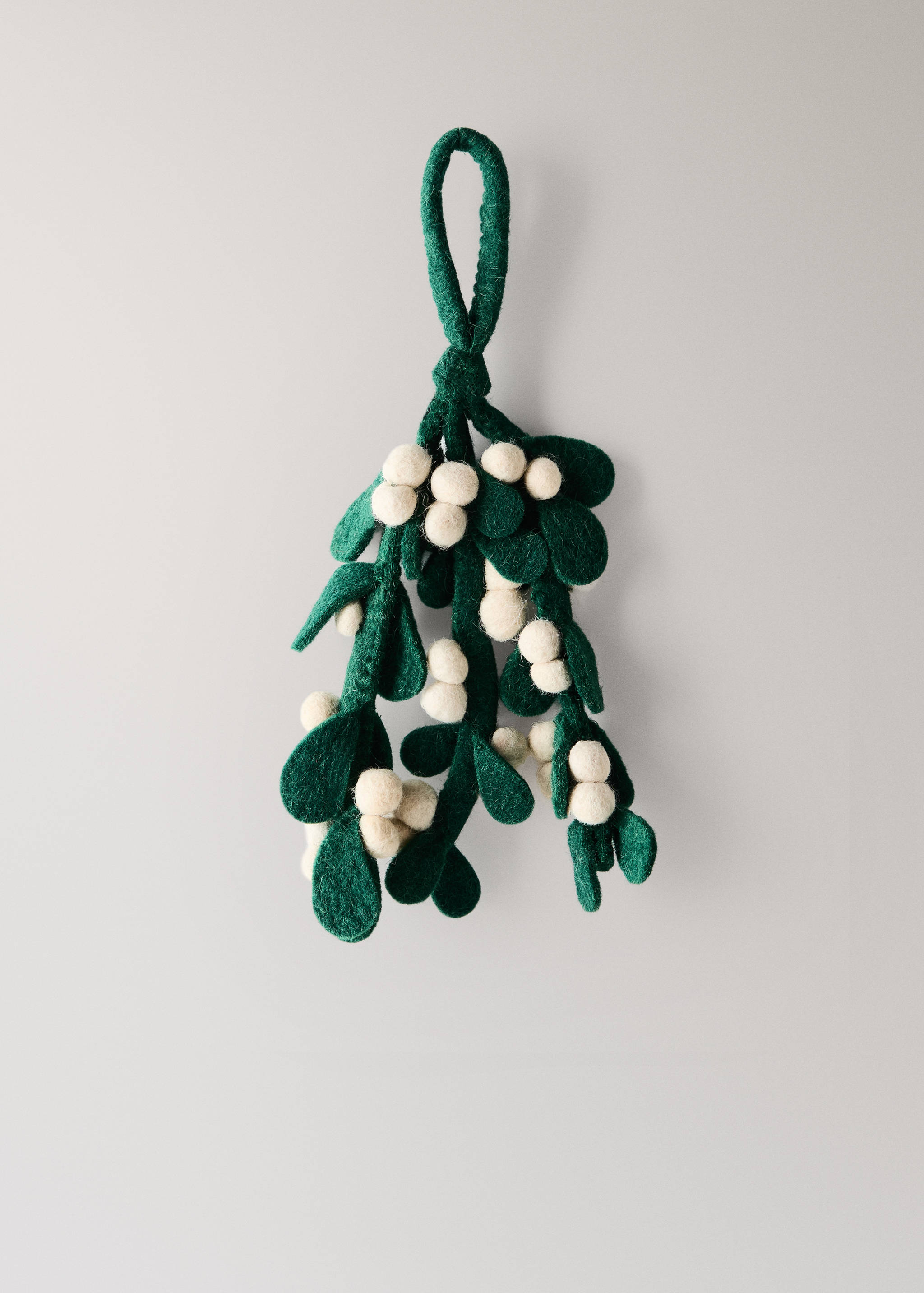 Green felt mistletoe decoration with white spherical berries and a hanging loop.