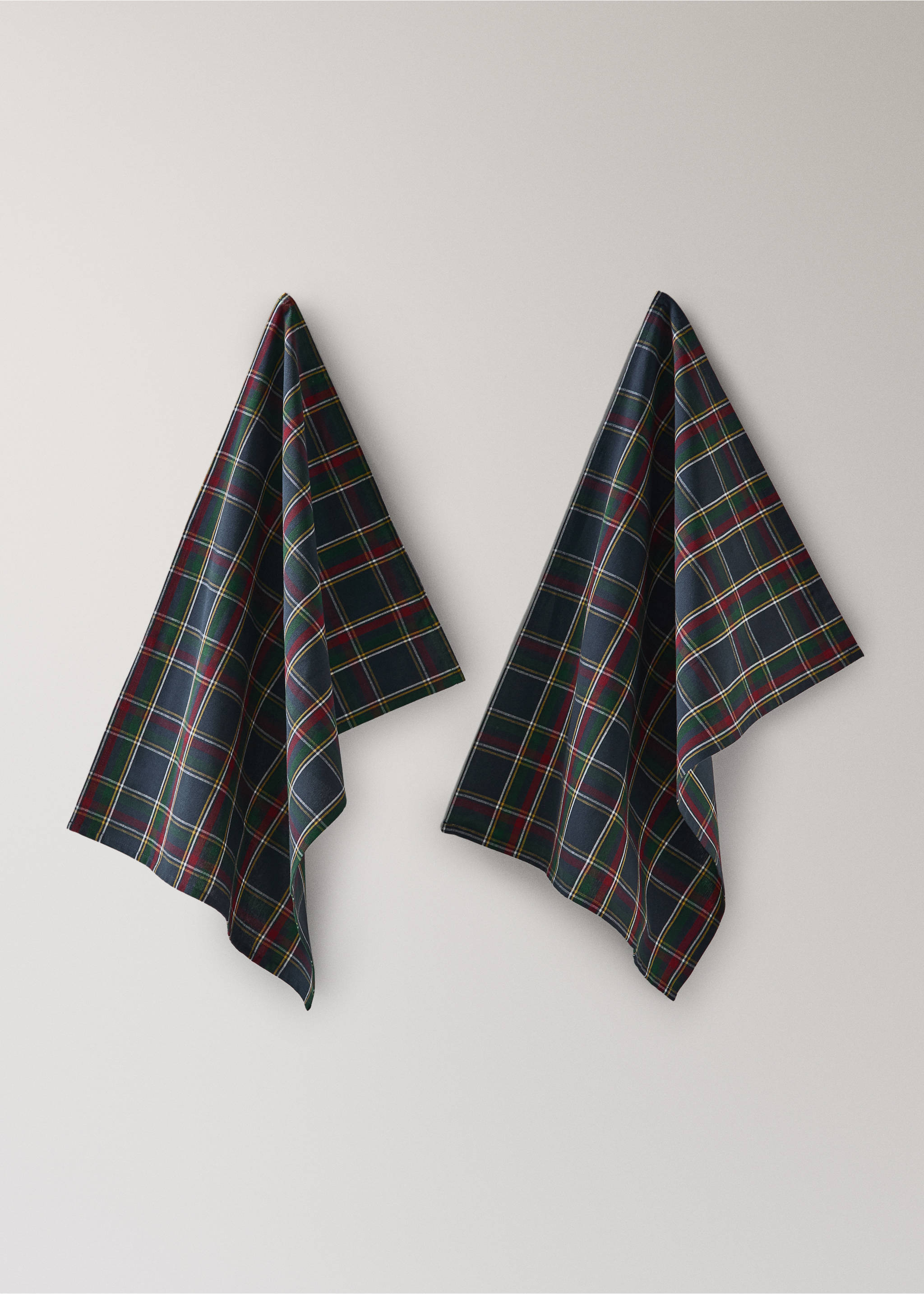 Two navy blue tartan plaid kitchen towels hanging against a neutral background., Blue. Ref: 37076732-00.