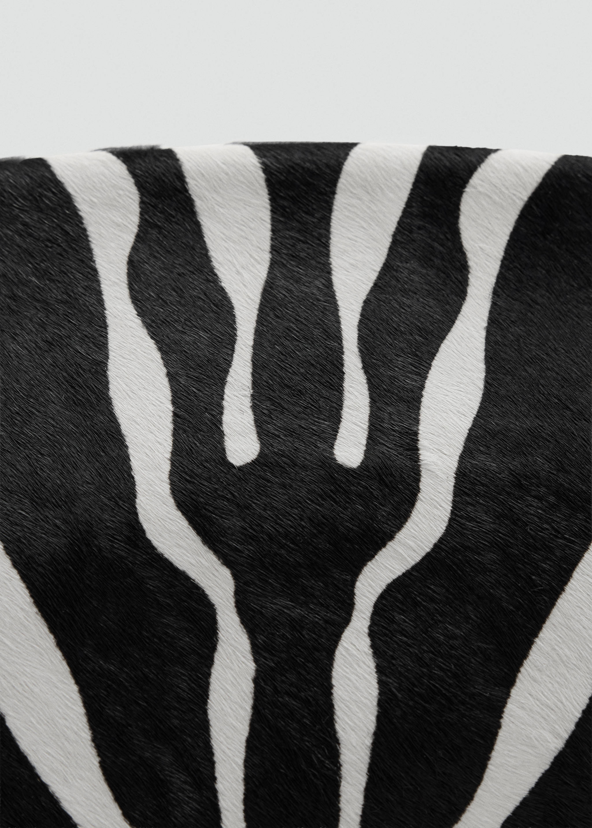 Zebra-print handbag detail with a textured hair-effect finish.