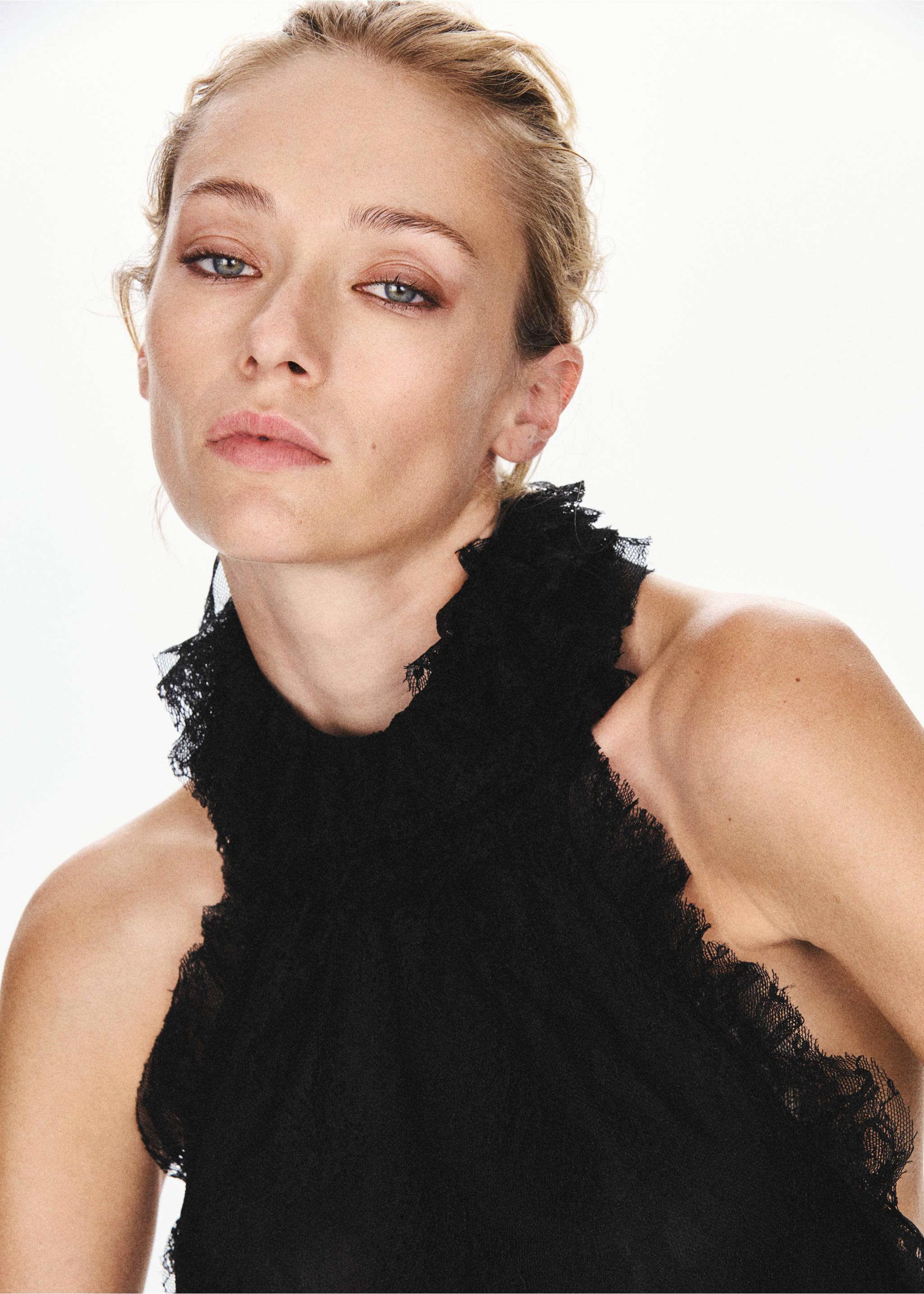 Close-up of a black sleeveless top with a ruffled high collar., Black. Ref: 37077778-00.