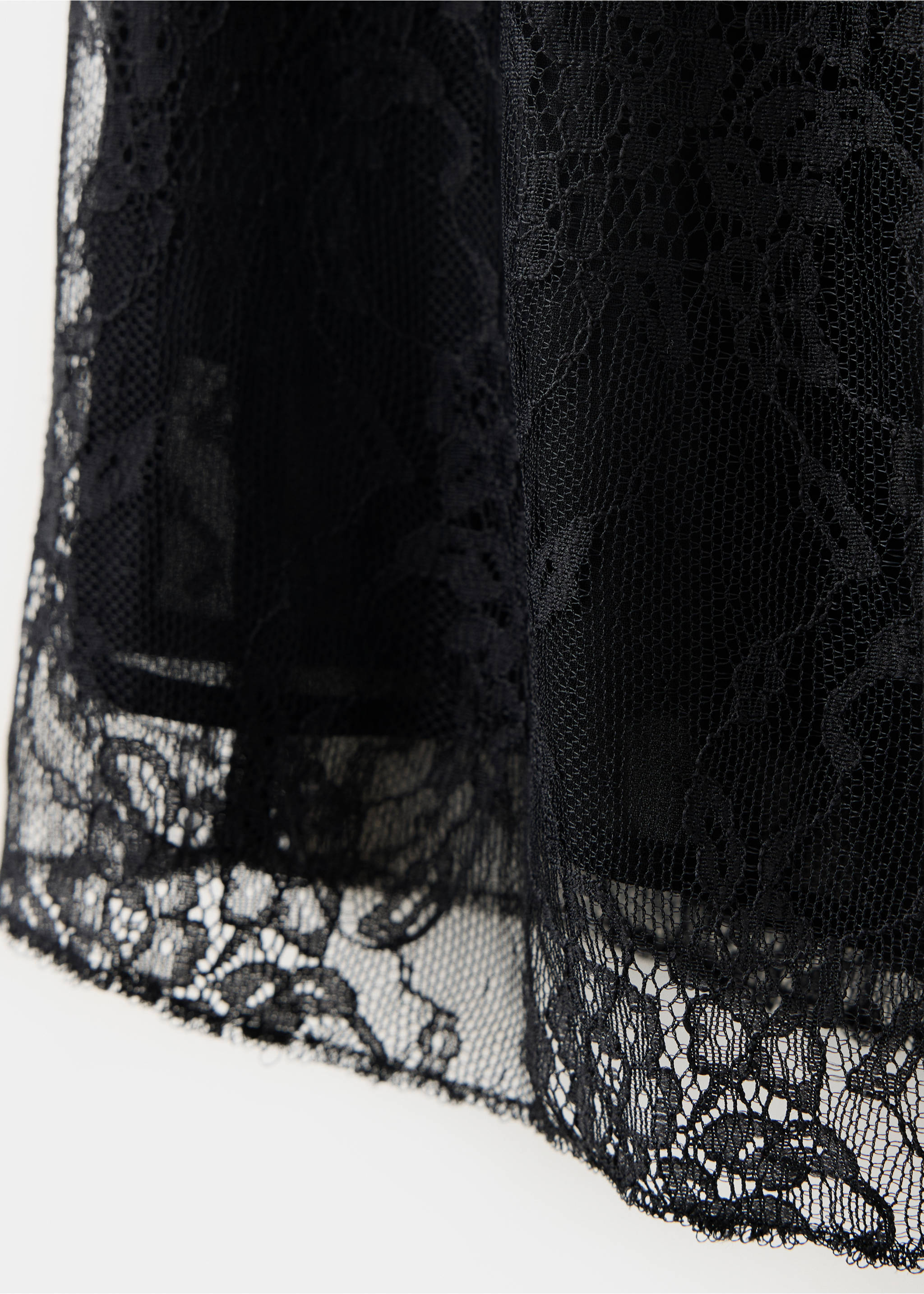 Close-up of black lace top showing the fabric texture and pattern., Black. Ref: 37077778-00.