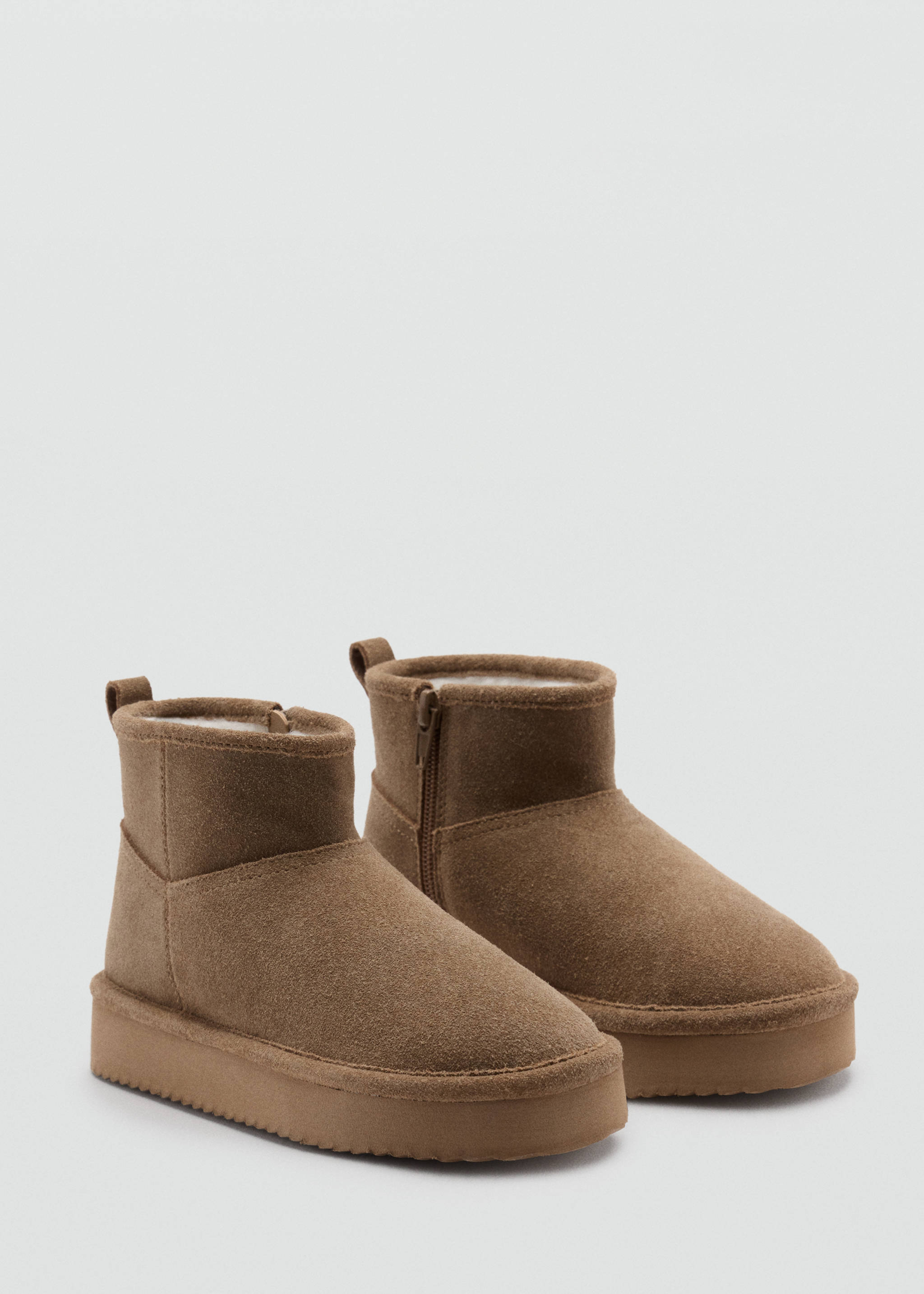 Brown ankle boots with platform soles, side zippers and faux-shearling lining.