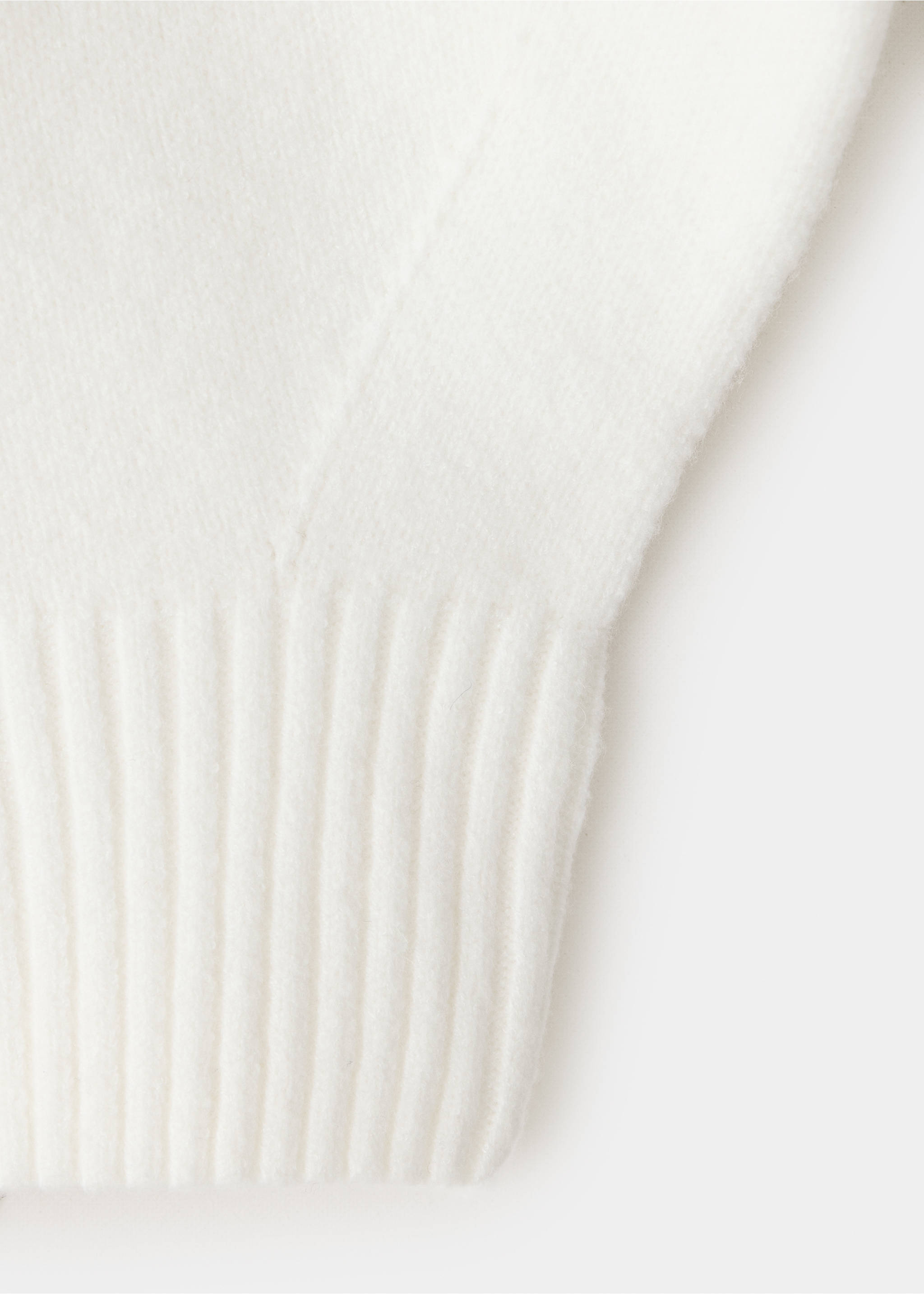 Close-up of white knit cape fabric and ribbed hem detail., Off White. Ref: 37077789-00.