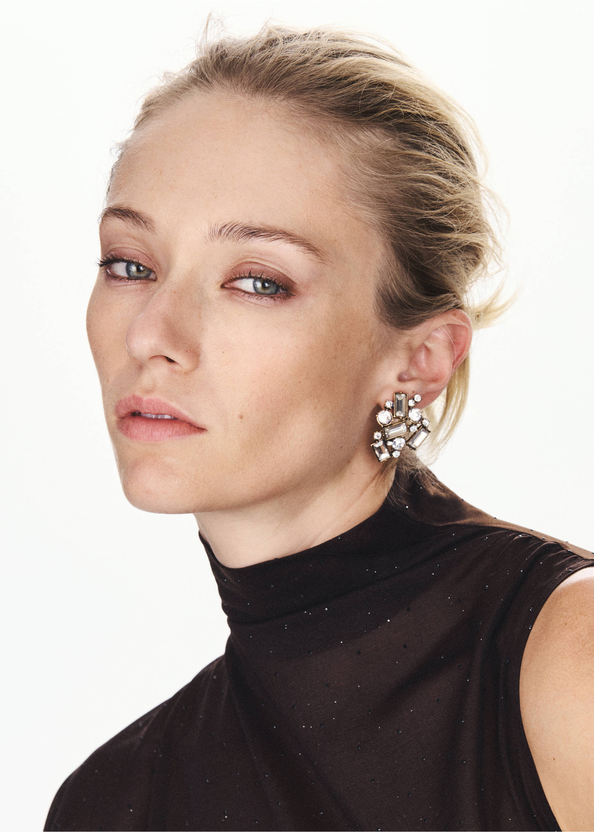 Close-up of a dark brown sleeveless high-neck top with subtle glitter detail on a model., Chocolate. Ref: 37077793-00.