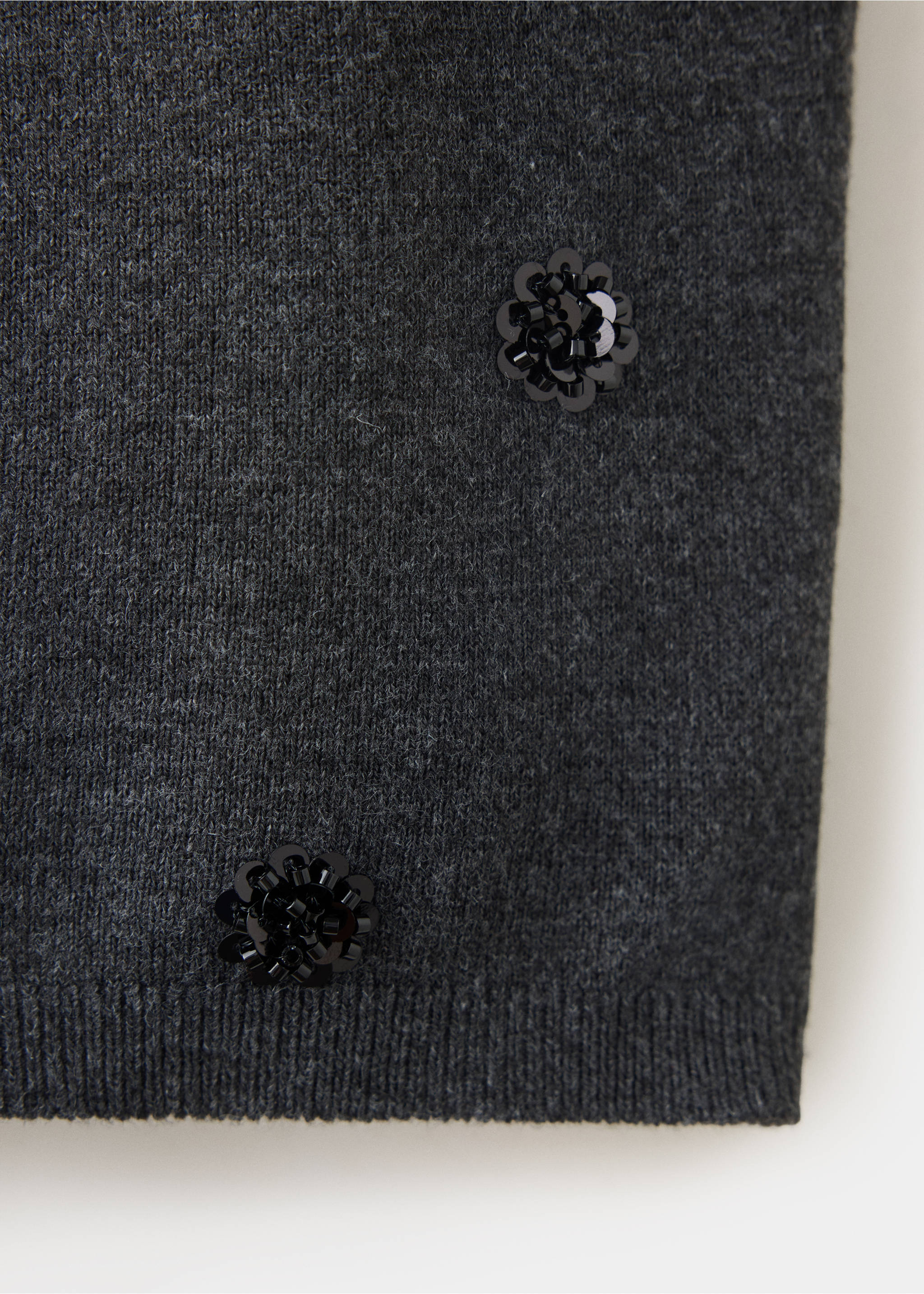 Close-up of a dark grey knit top with sequin flower details., Charcoal. Ref: 37077796-00.