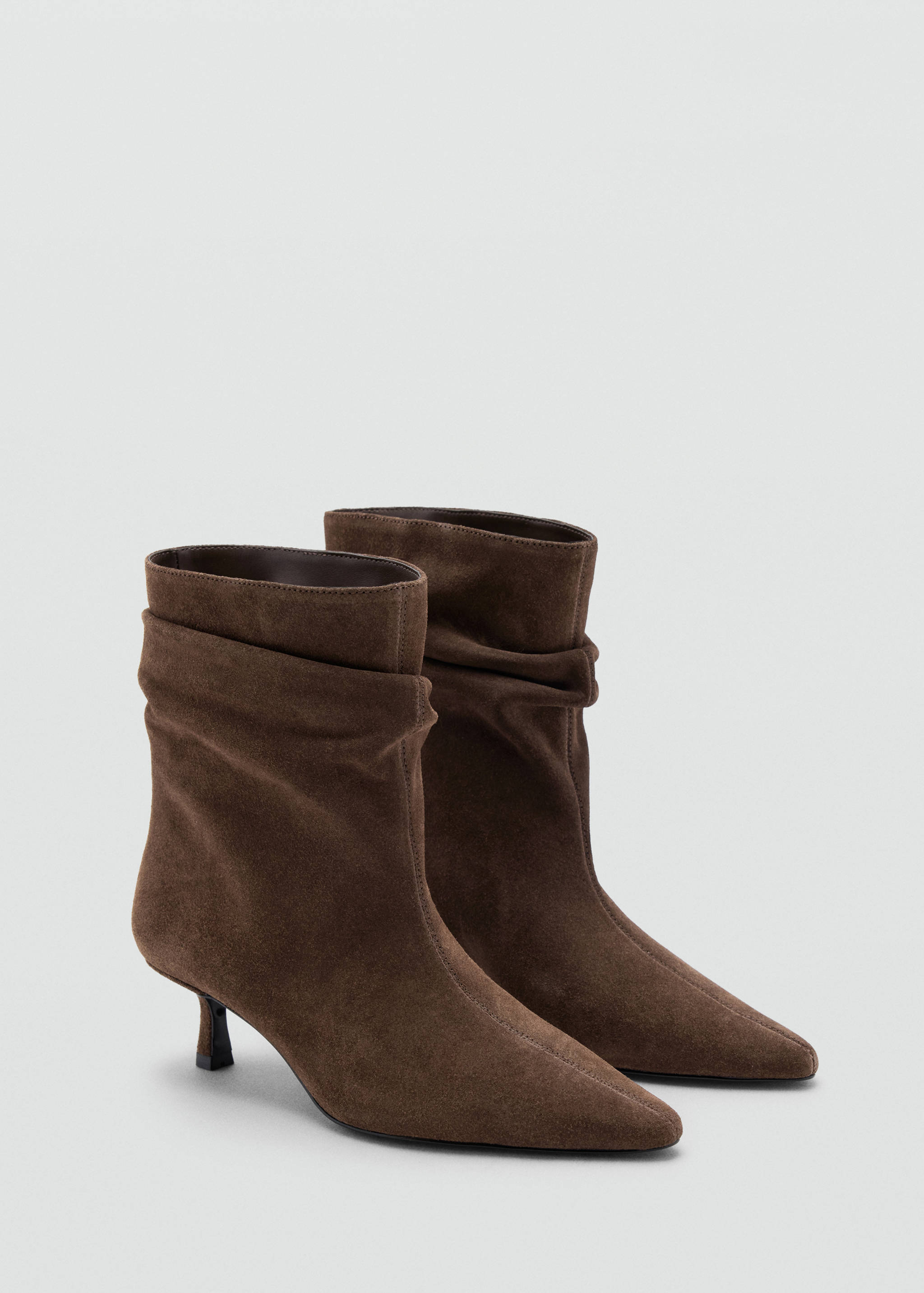 Brown suede ankle boots with pointed toes and kitten heels.