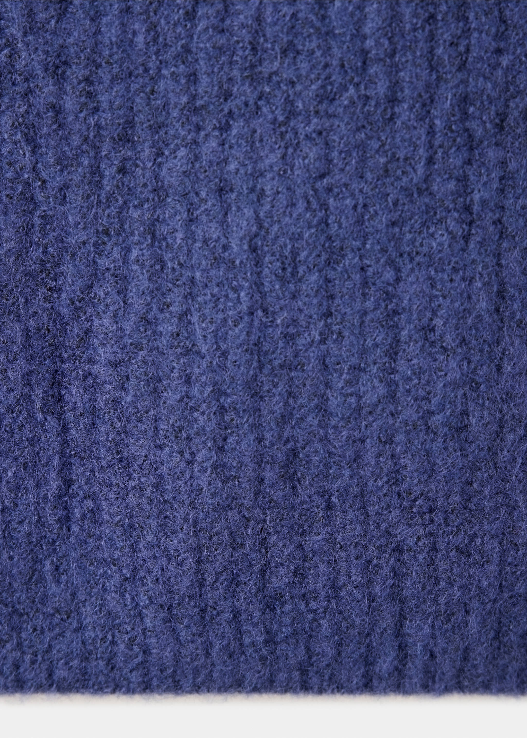 Close-up of the dark blue textured knit fabric of a vest., Indigo Blue. Ref: 37077809-00.