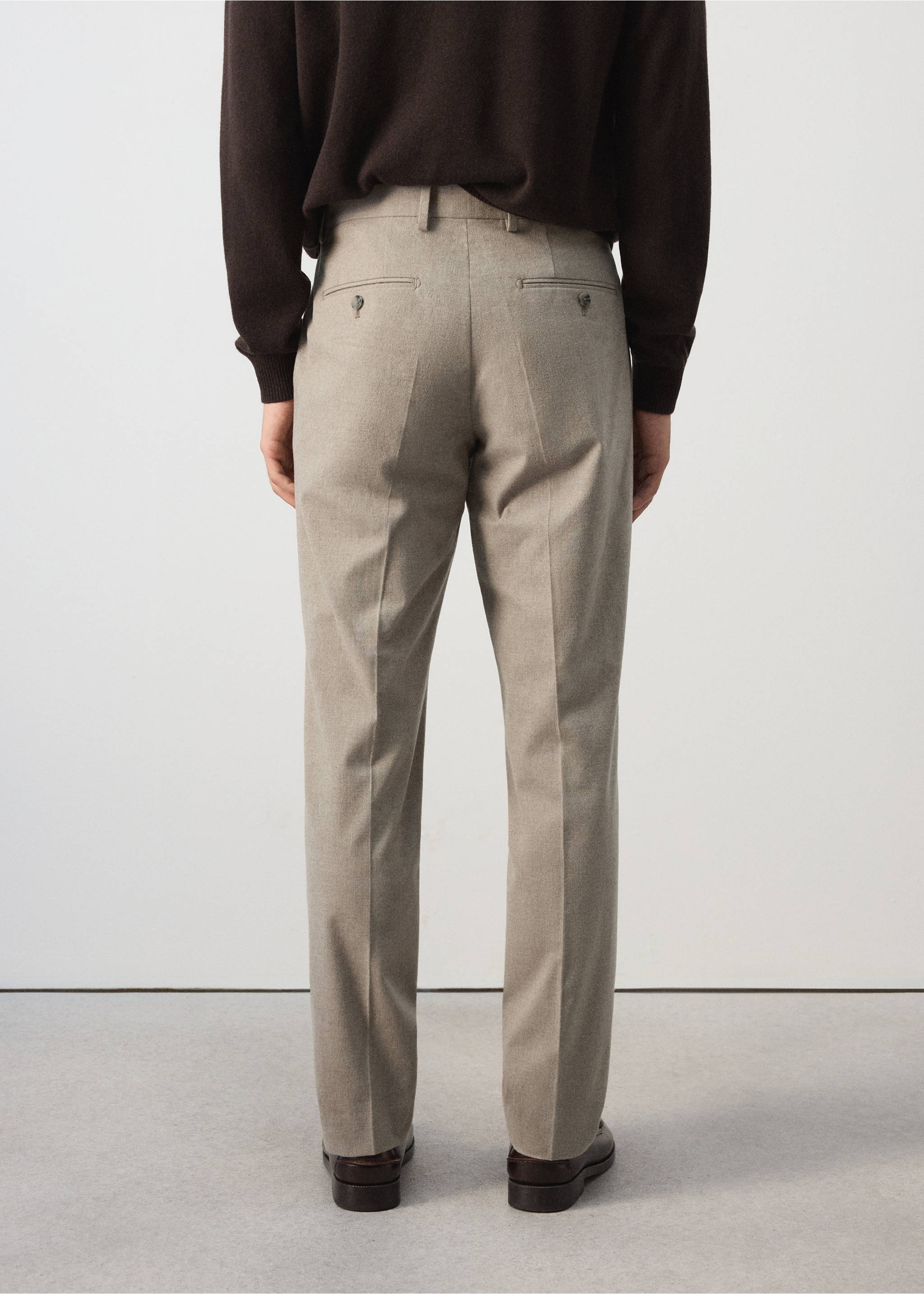 Beige trousers seen from the back, featuring belt loops and buttoned welt pockets., Beige. Ref: 37077882-00.