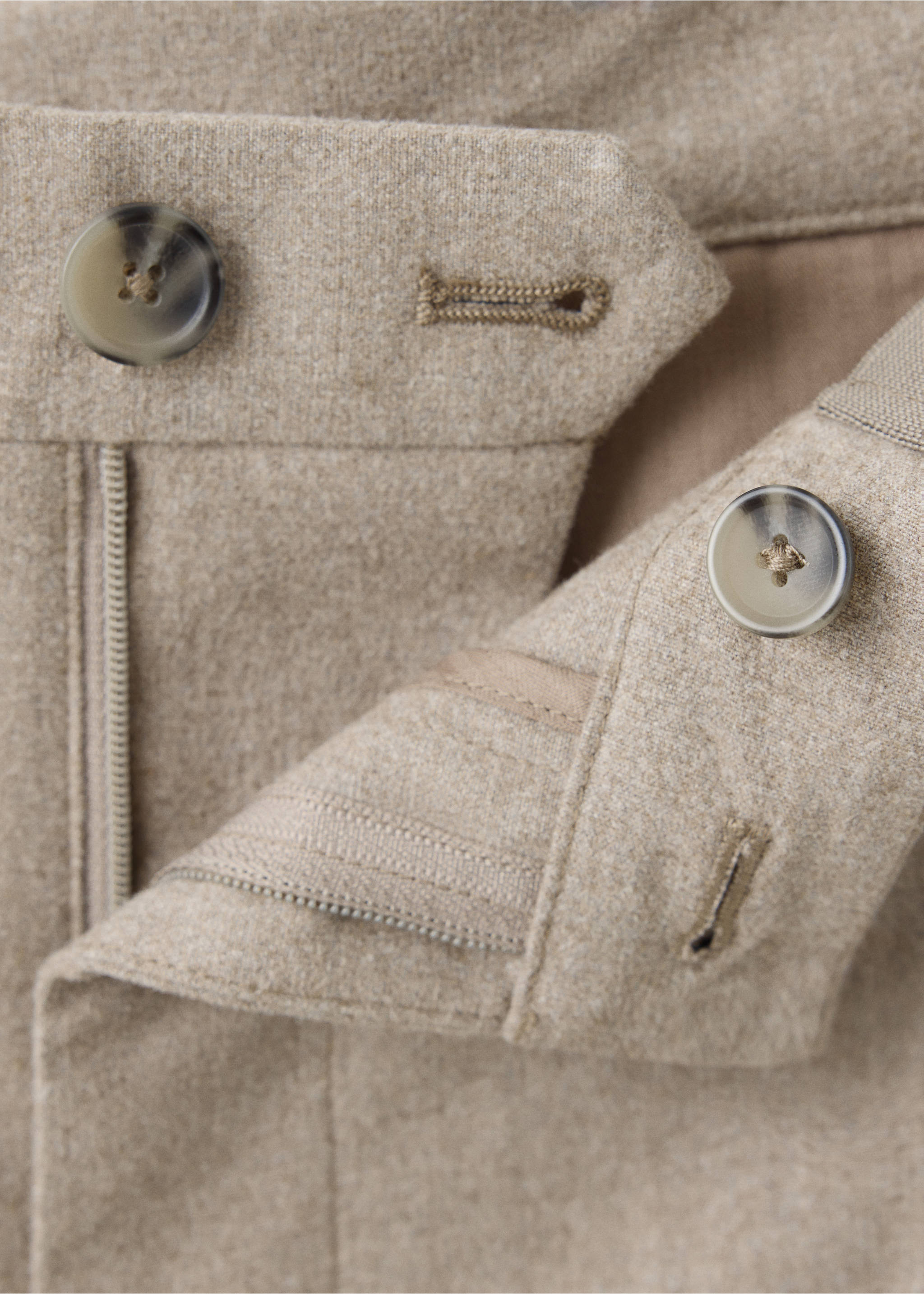 Beige trousers detail showing the waistband and button closure., Beige. Ref: 37077882-00.