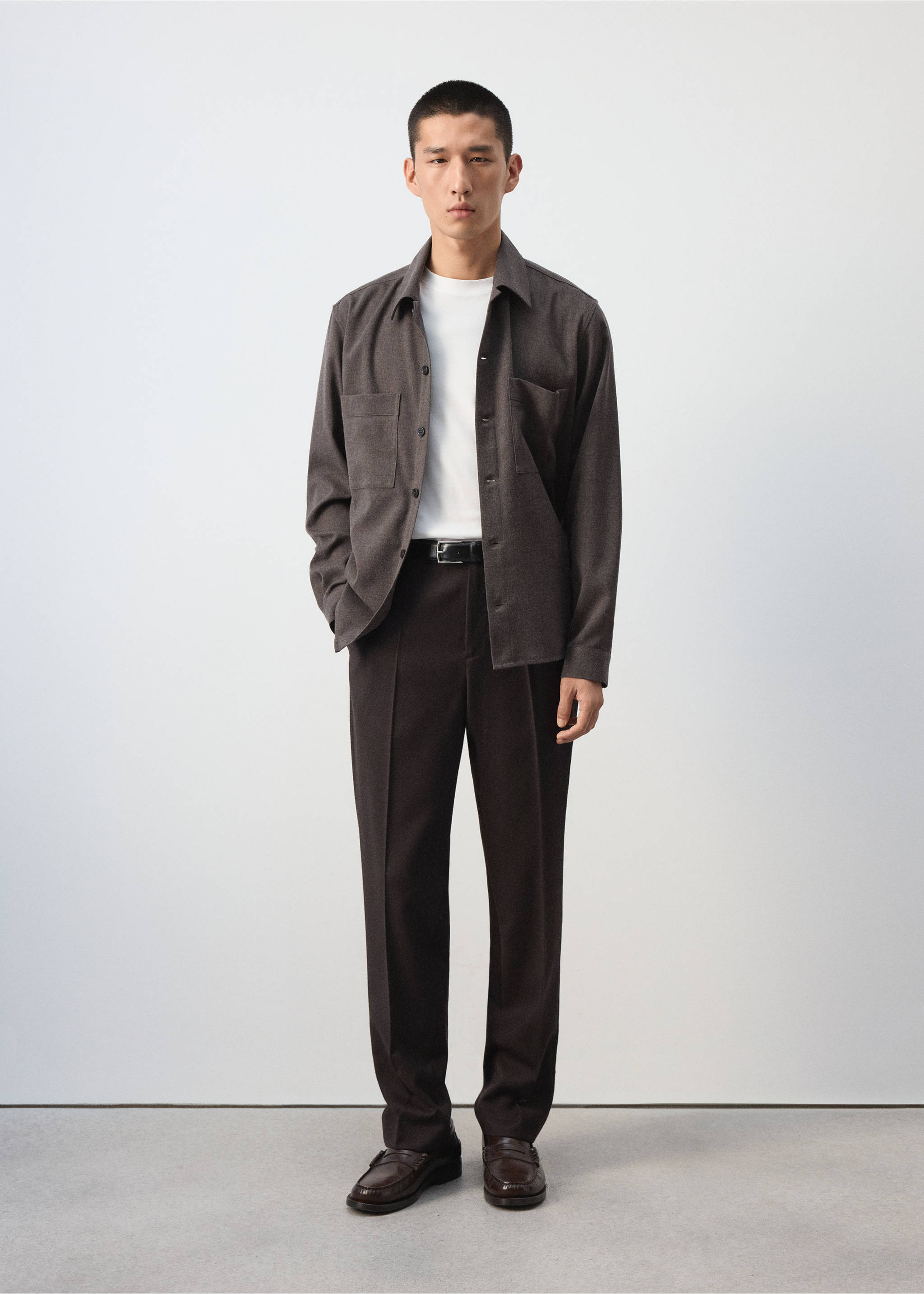 Dark brown overshirt with a classic collar and chest pockets, worn over a white t-shirt with dark trousers., Brown. Ref: 37077884-00.