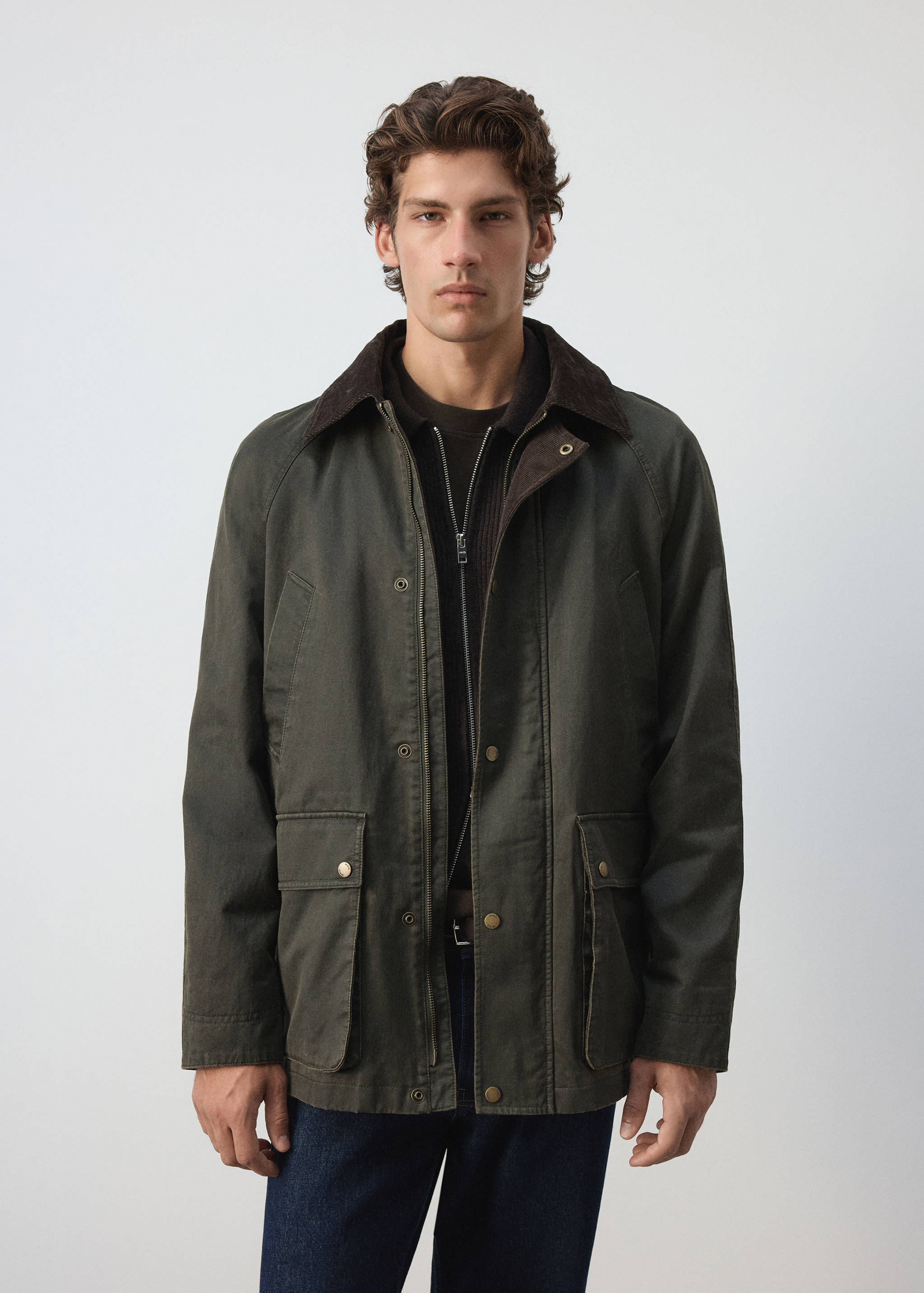 Dark green parka with a brown corduroy collar and front patch pockets.