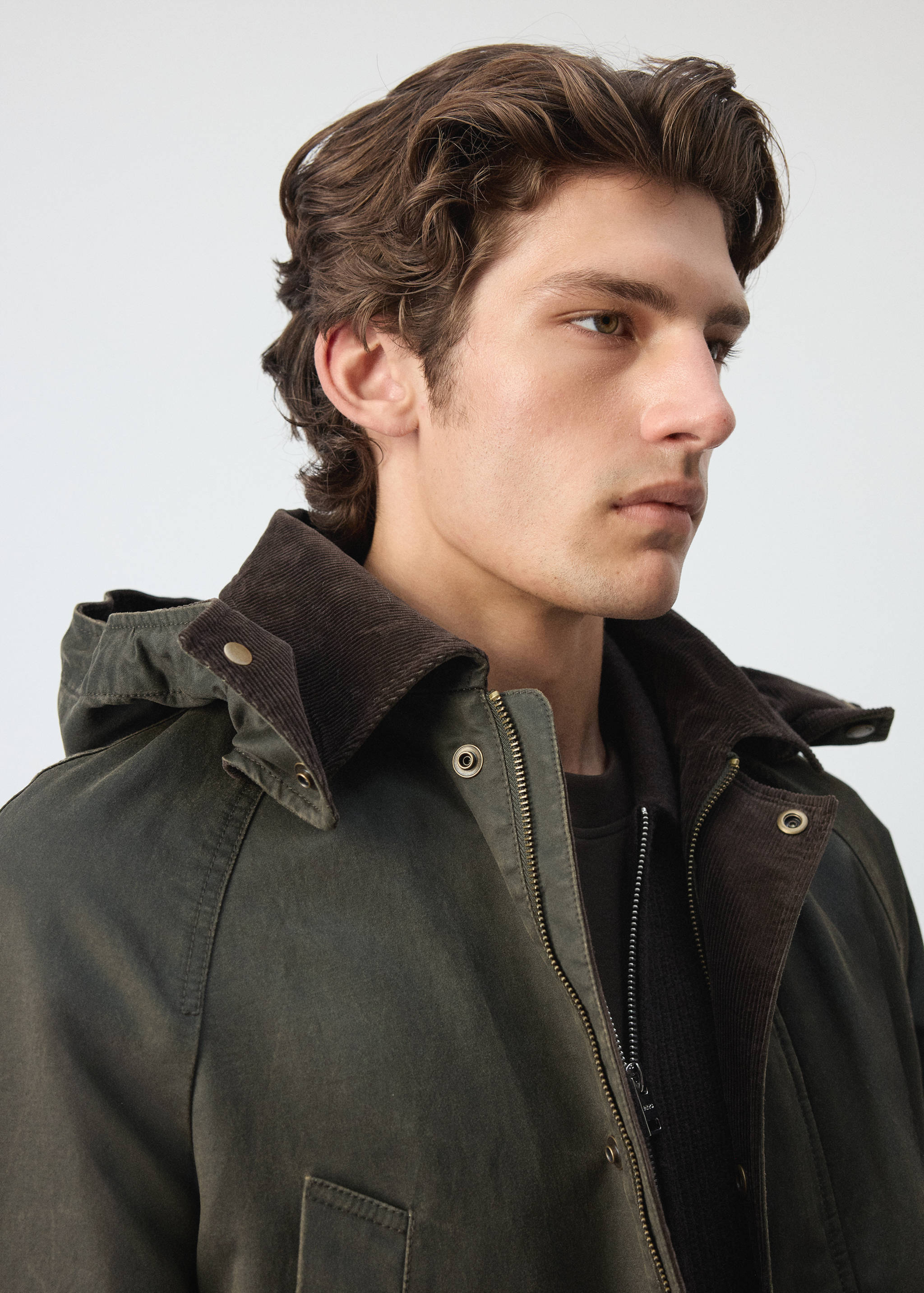 Dark green parka with a brown corduroy collar and hood.