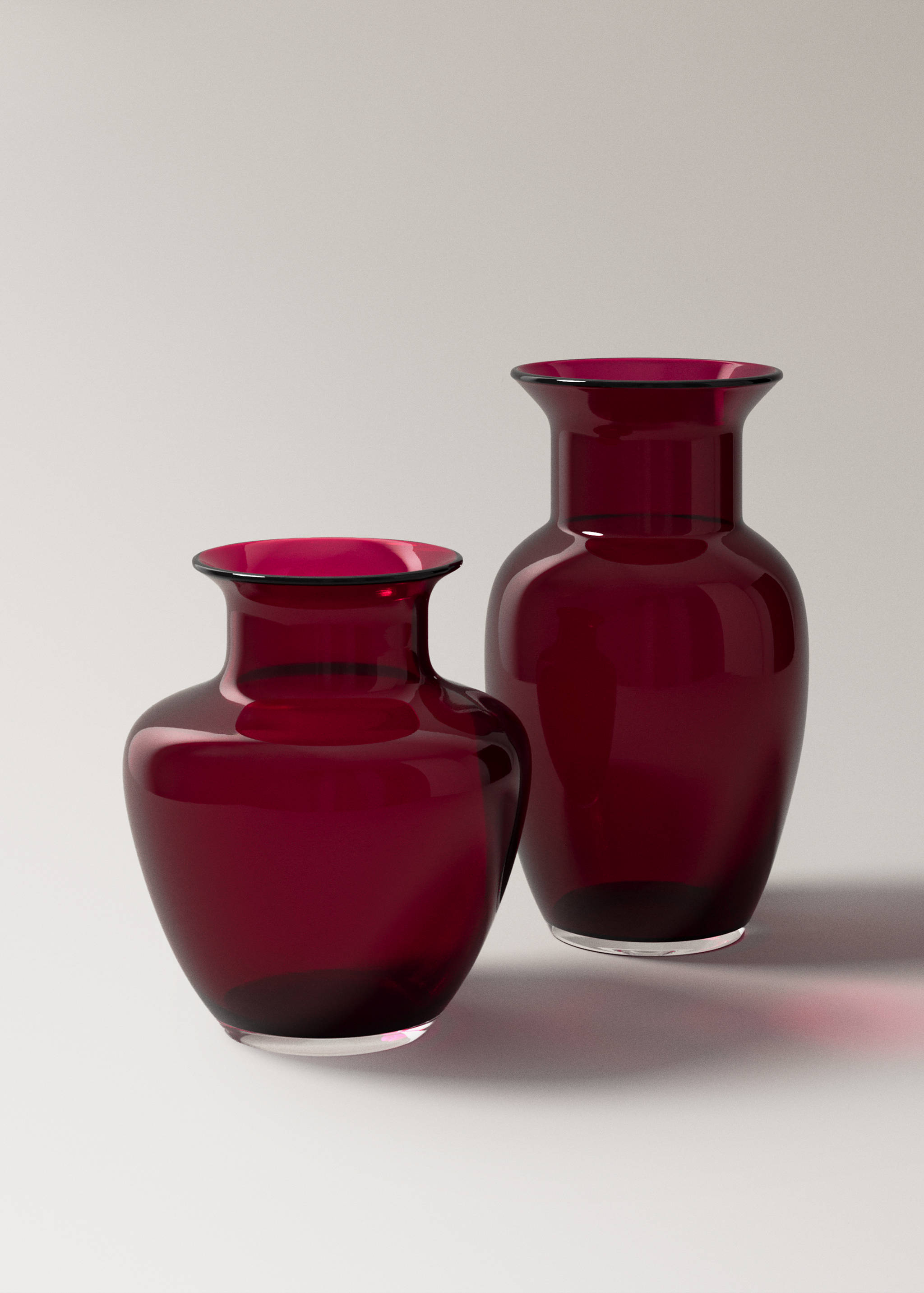Two dark pink glass vases of different sizes.