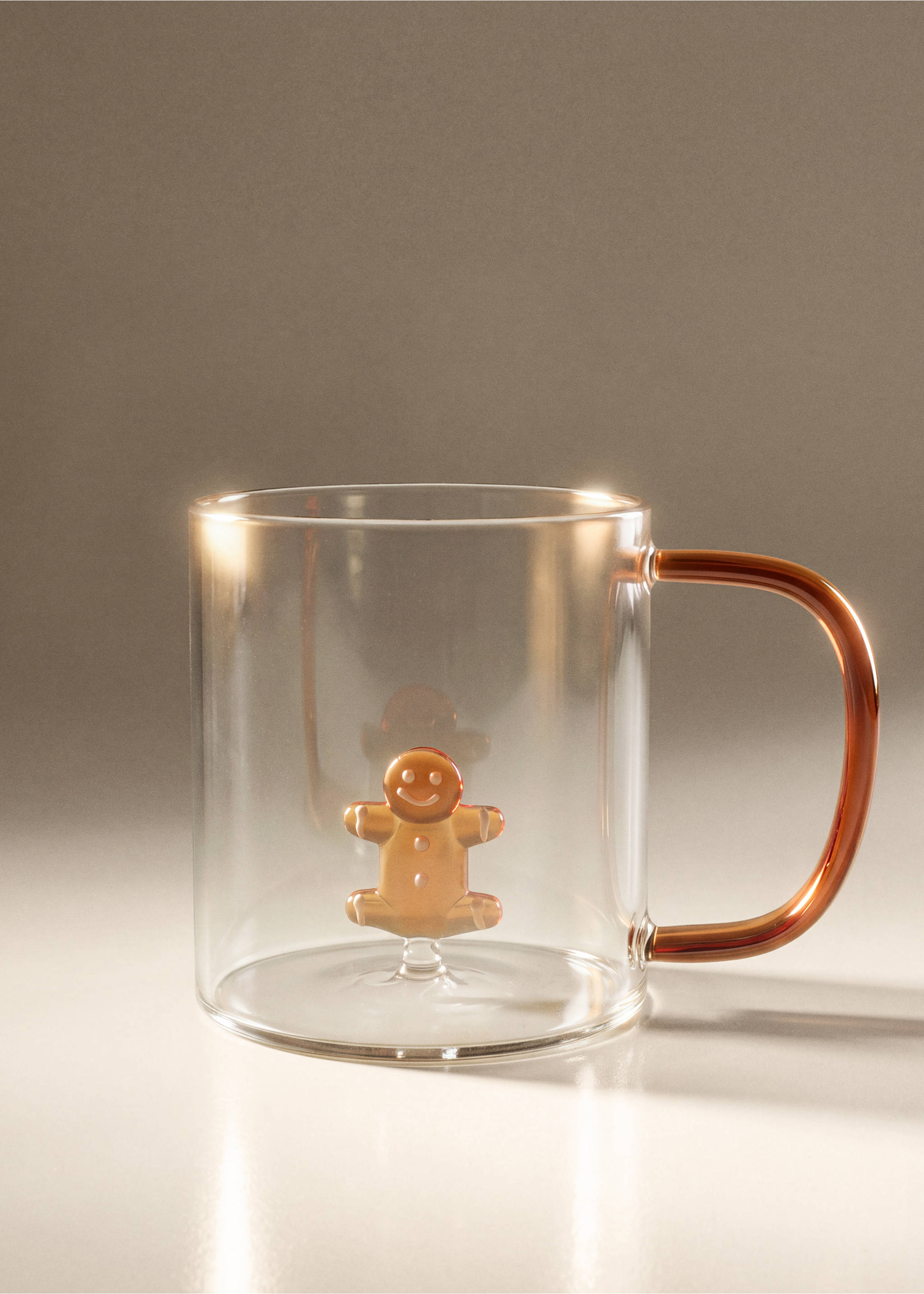 Clear glass mug with a metallic brown handle and interior gingerbread man figure., Russet. Ref: 37077890-00.