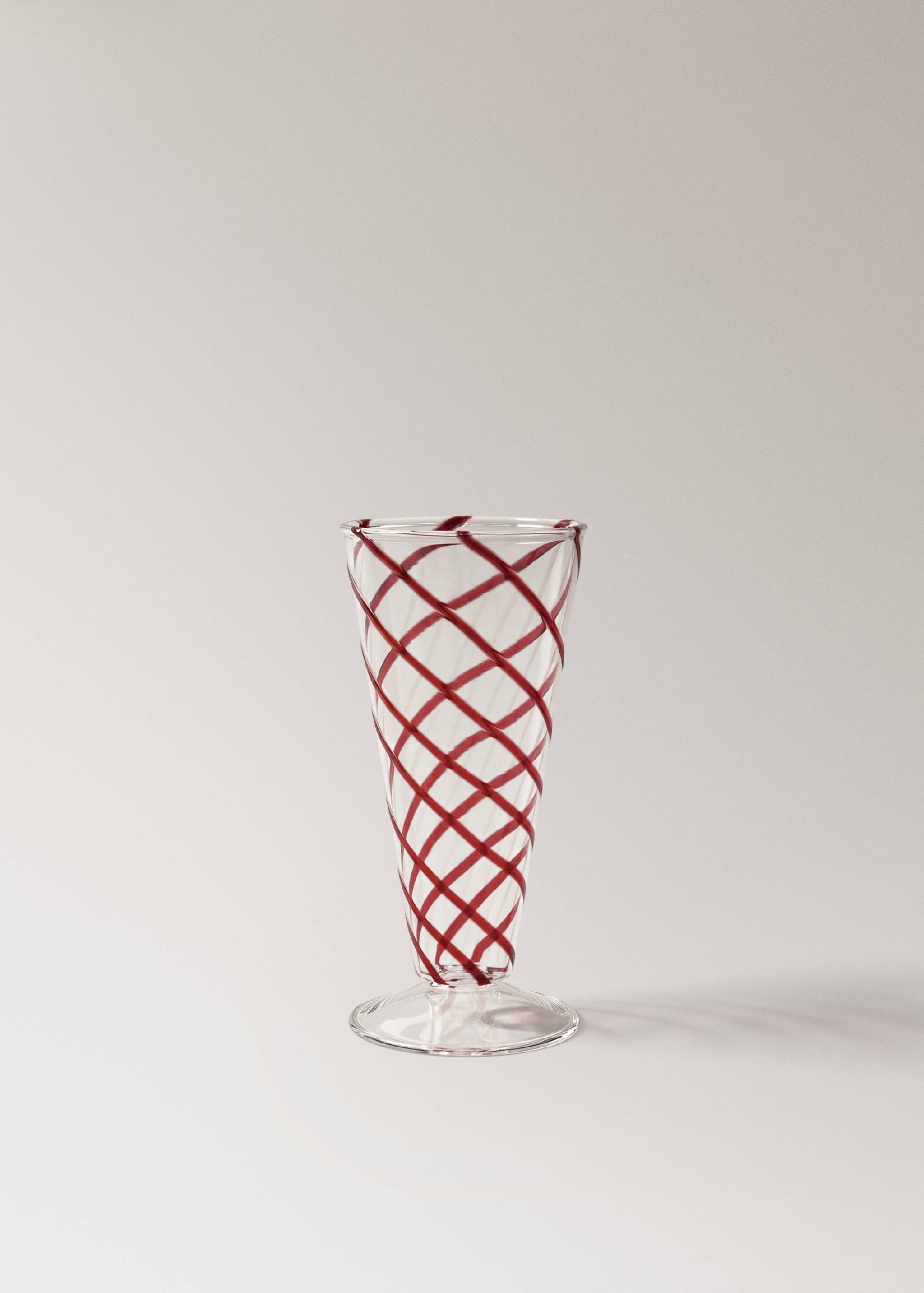 Clear glass goblet with a red crisscross pattern.
