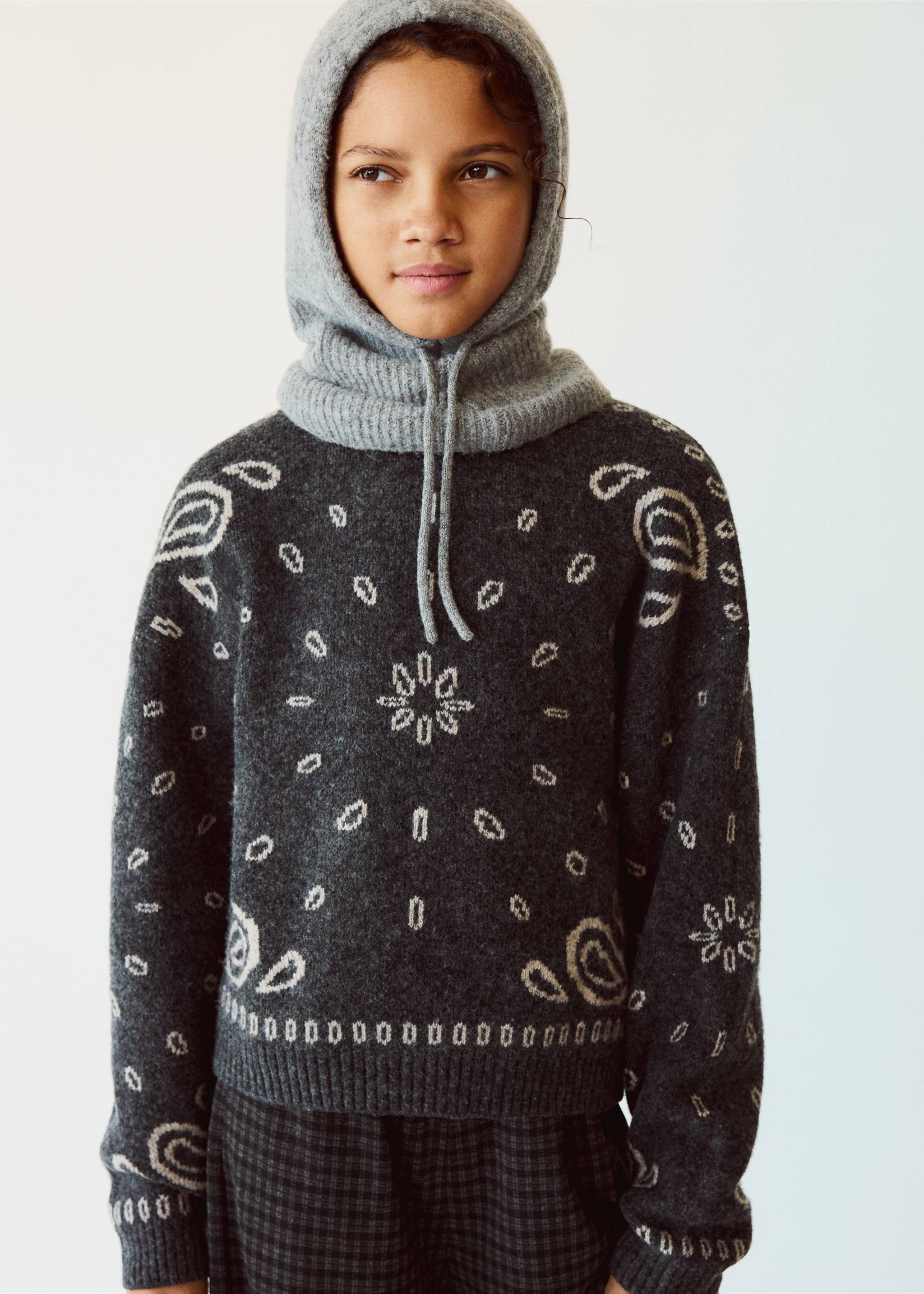 Grey knitted balaclava with a ribbed neck and drawstring ties.
