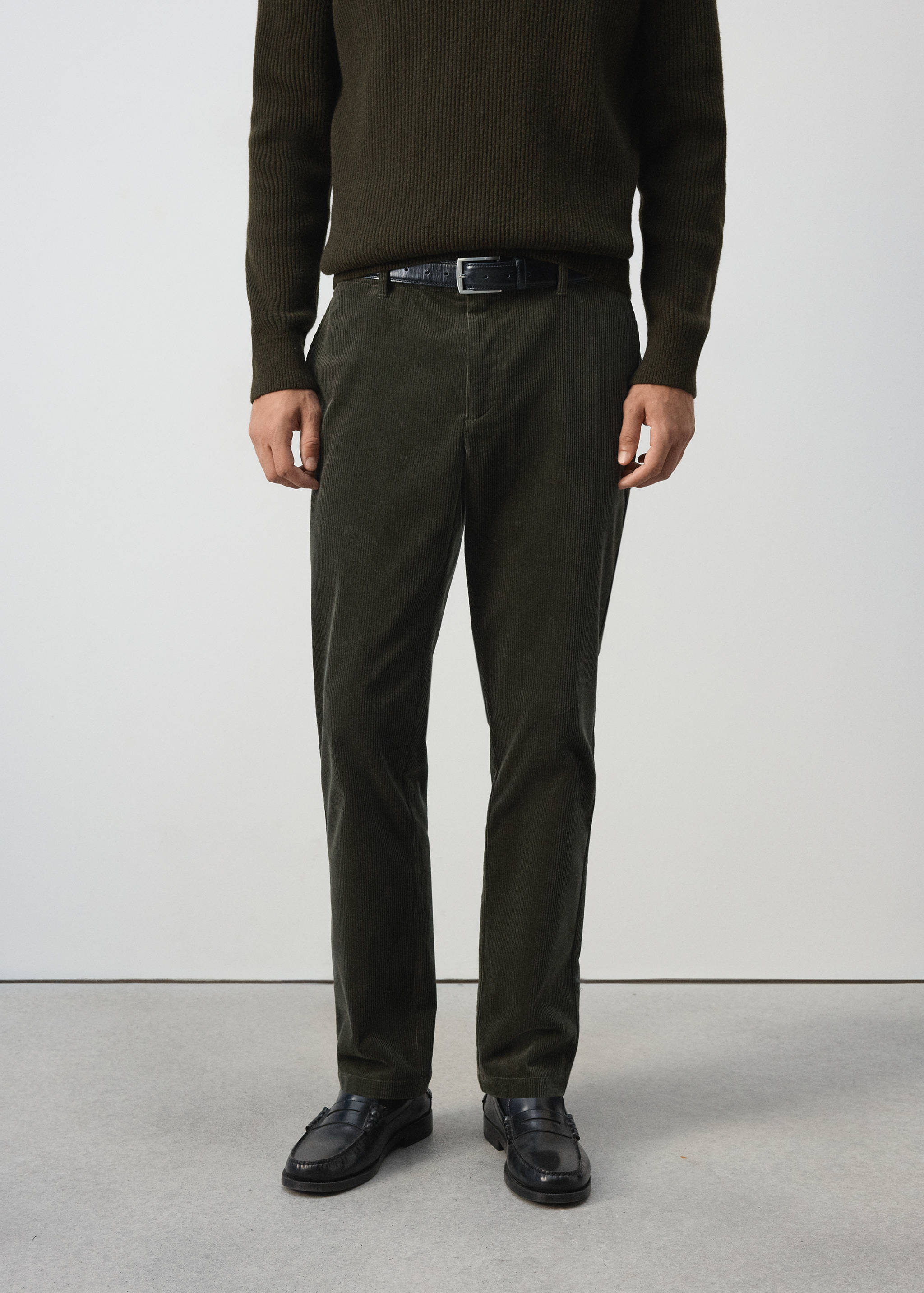 Dark green corduroy trousers in a straight fit.
