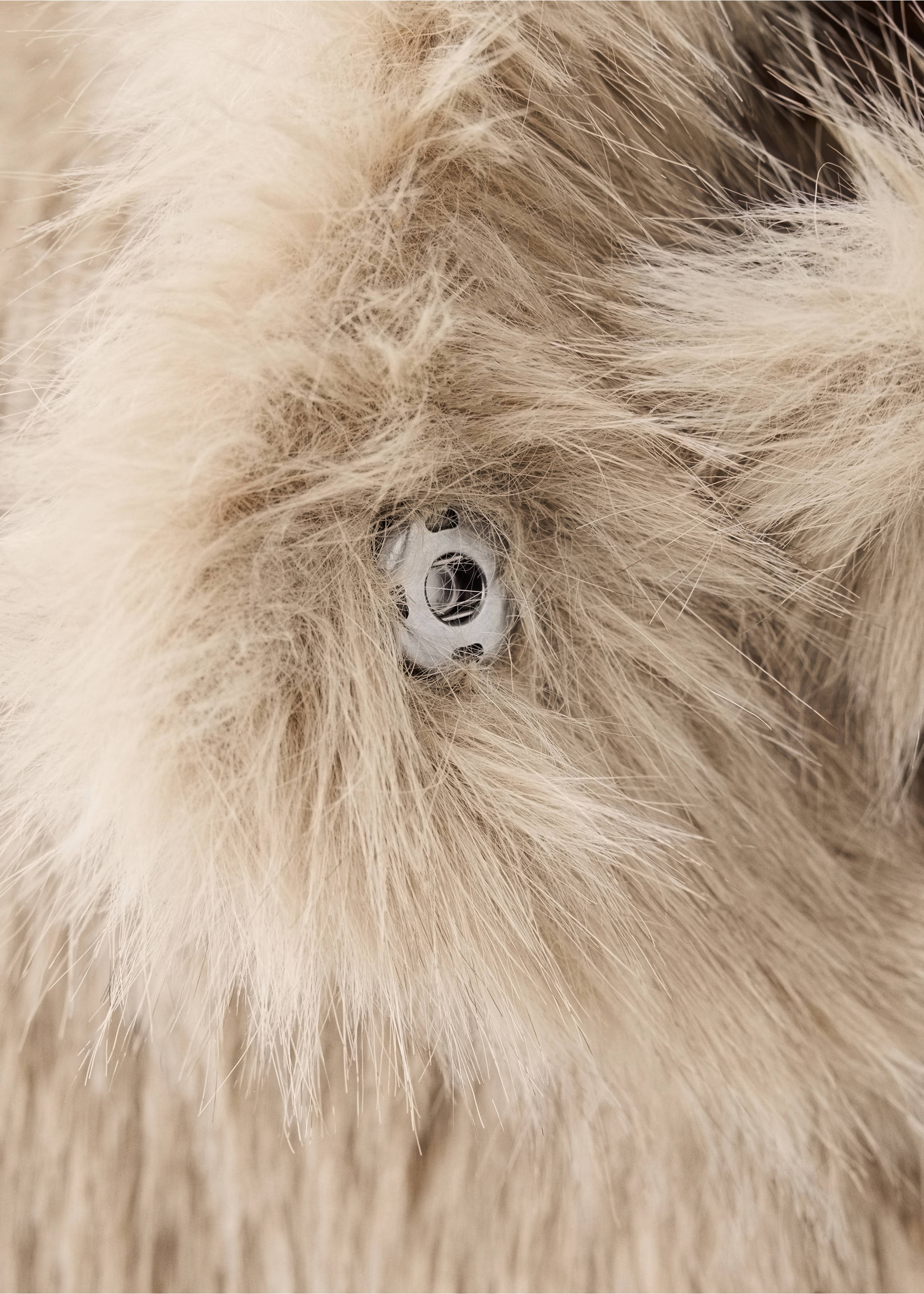 Close-up of a beige faux-fur coat detail showing the plush texture and fastener., Beige. Ref: 37077905-00.
