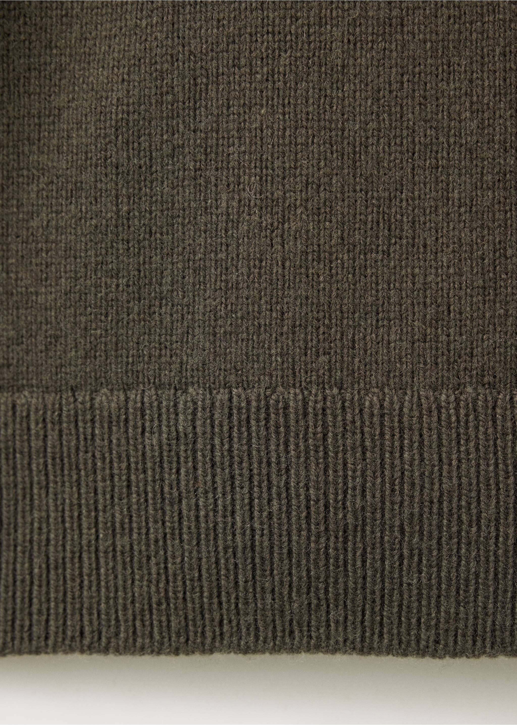 Close-up of the ribbed hem and fine knit texture of a dark khaki green sweater., Khaki. Ref: 37077908-00.