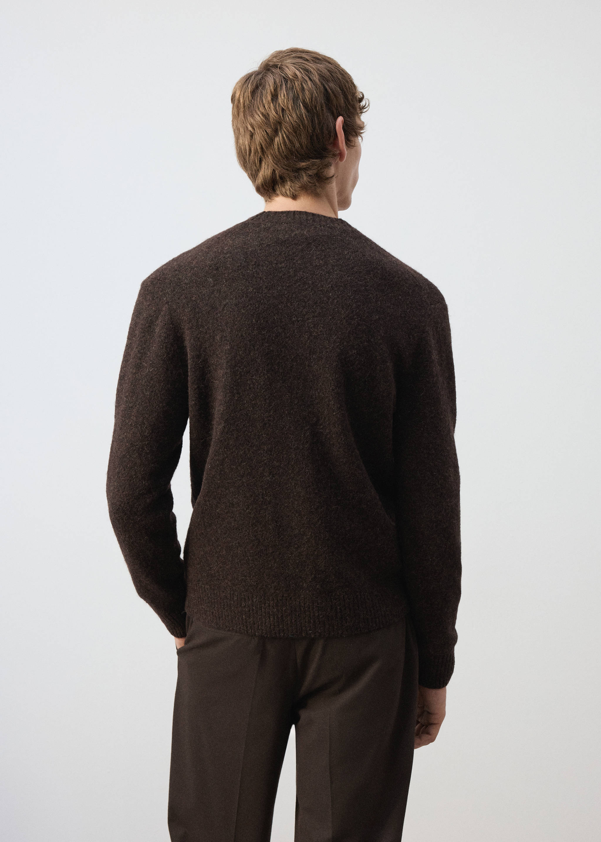 Back view of a dark brown knitted cardigan with a crew neck.