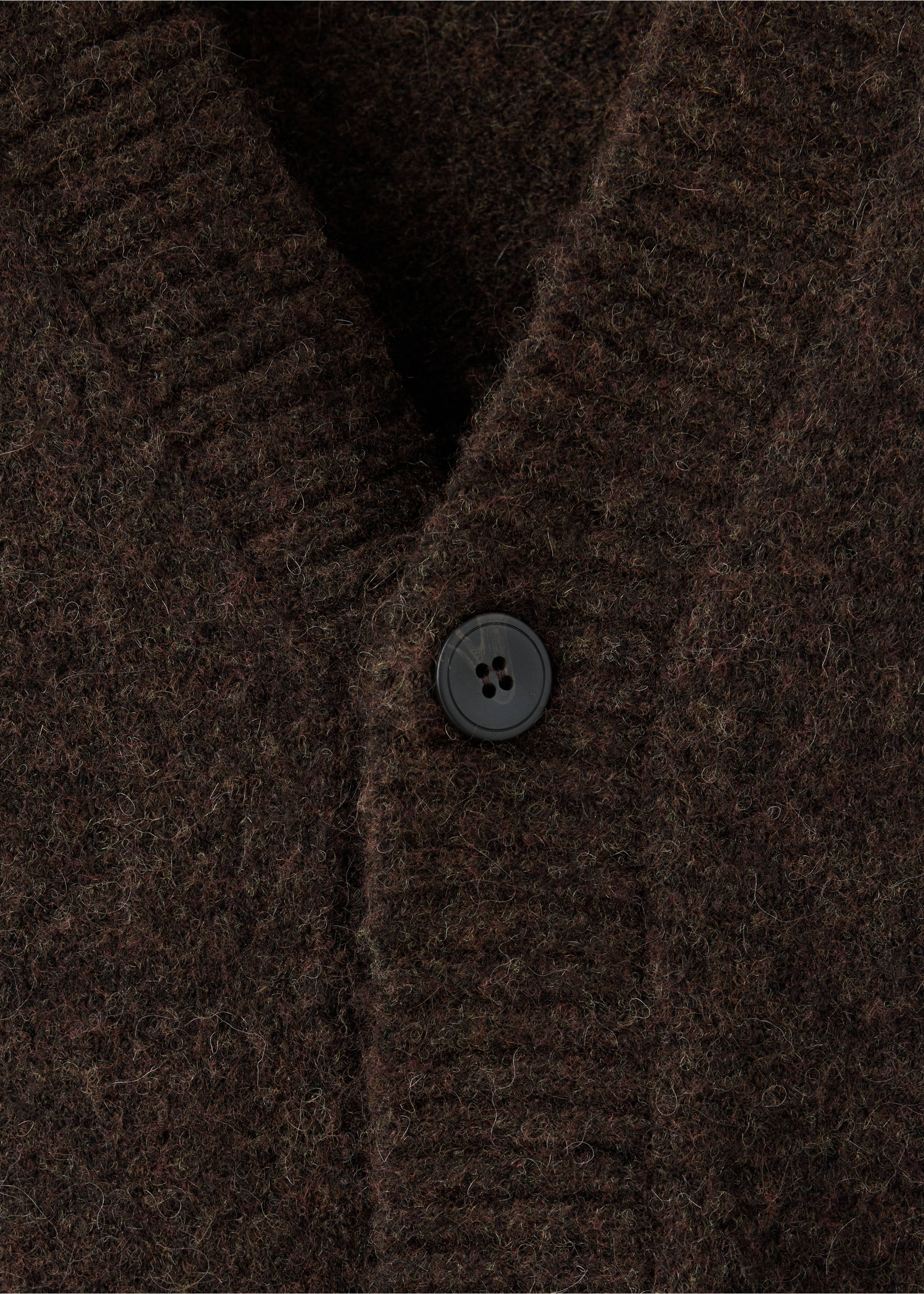 Close-up of a brown knitted cardigan with a V-neck and button detail., Chocolate. Ref: 37077915-00.