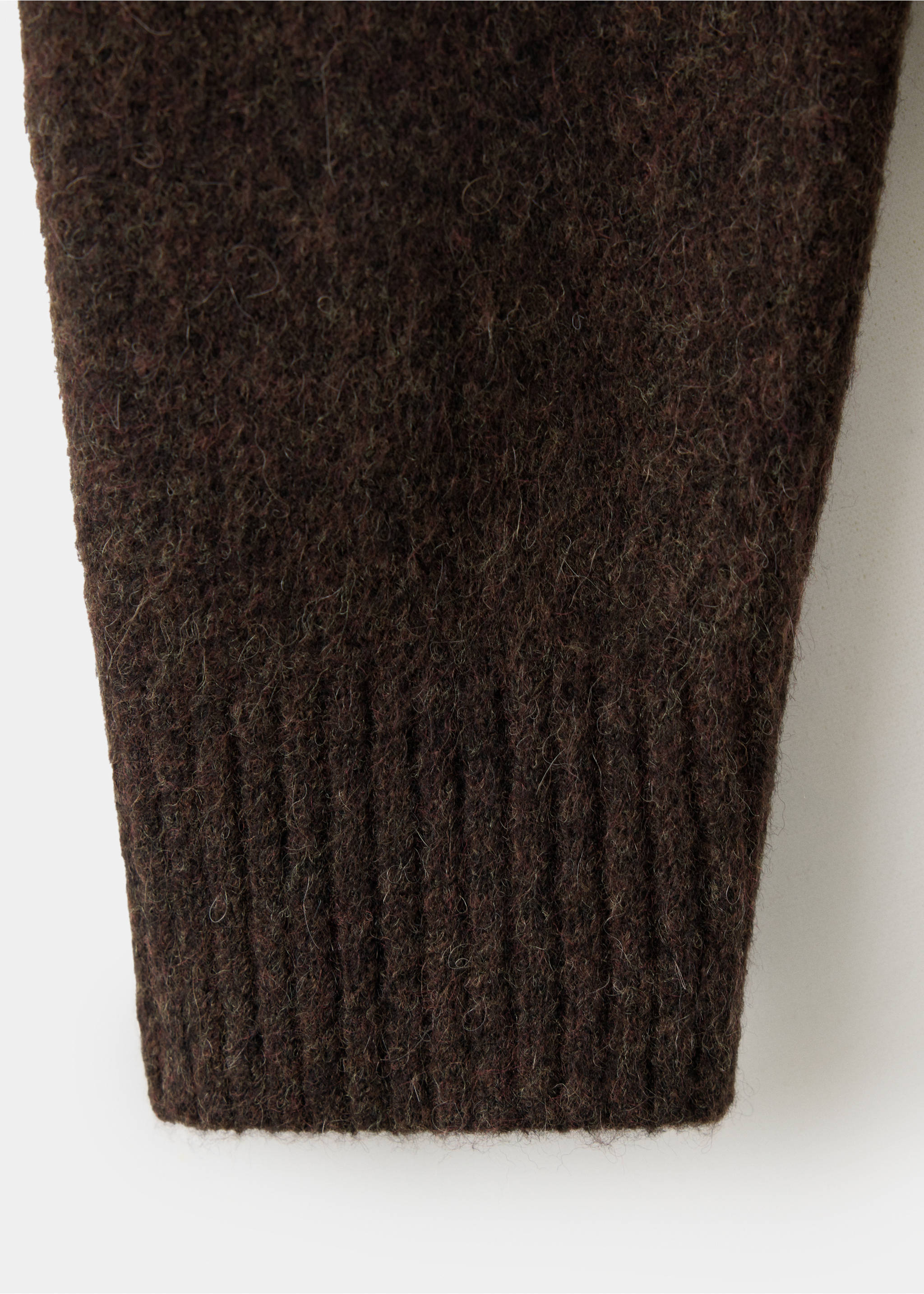 Close-up of the fuzzy texture and ribbed cuff of a dark brown cardigan., Chocolate. Ref: 37077915-00.