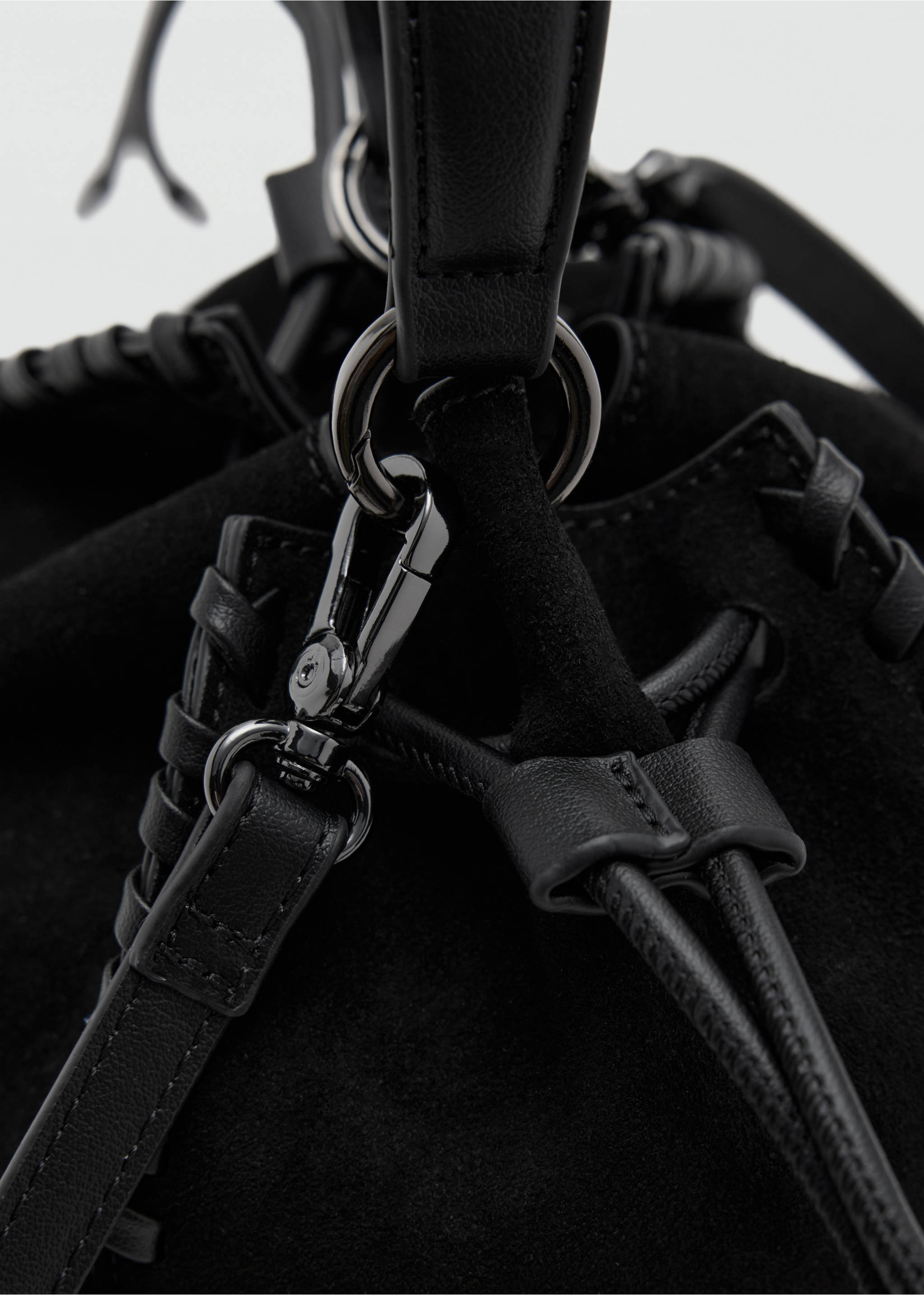 Close-up of a black mini bag showing strap hardware and braided trim detail., Black. Ref: 37077927-00.