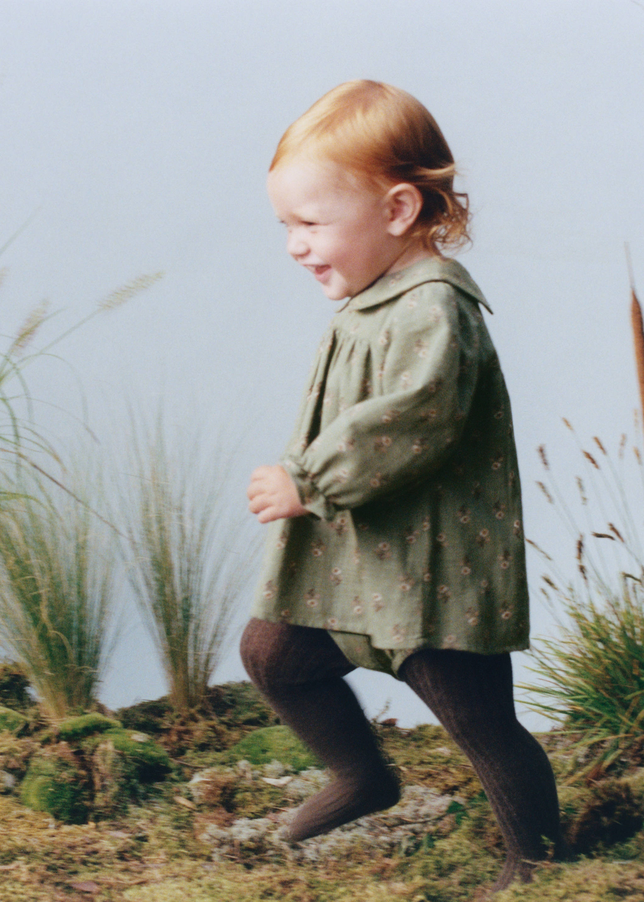 Green floral dress with a rounded collar and long sleeves.