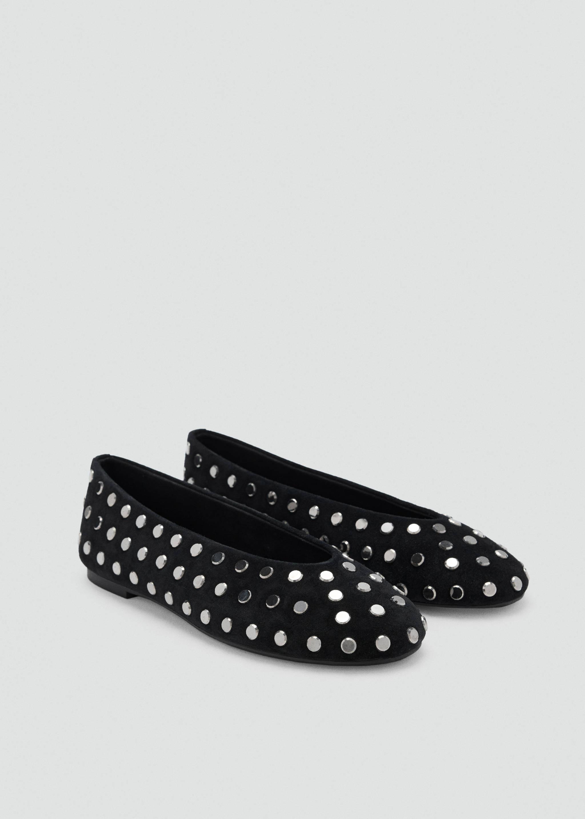 Black flat shoes with a rounded toe and silver-toned metallic studs.
