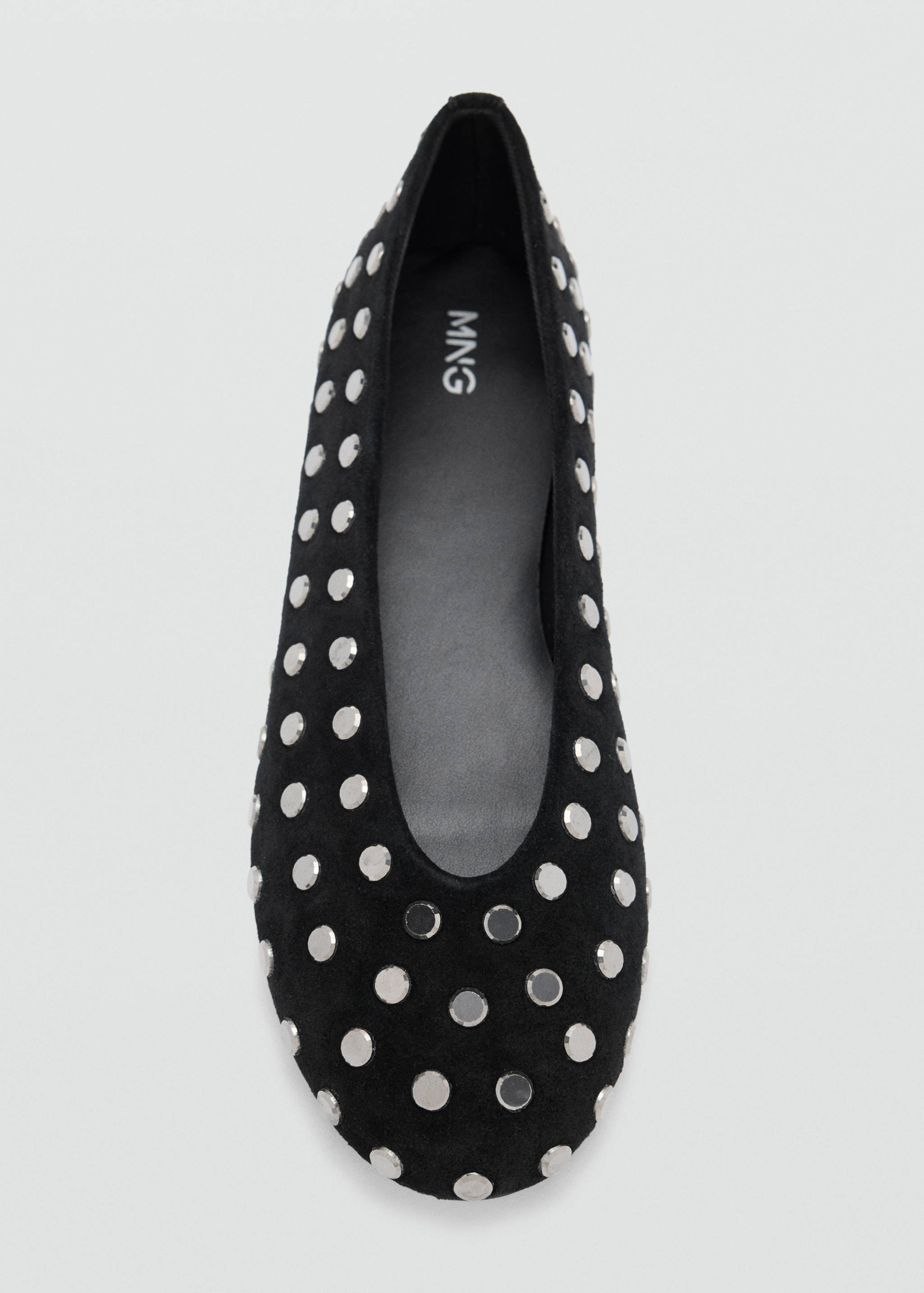 Black flat shoe with a rounded toe and all-over silver metallic studs.