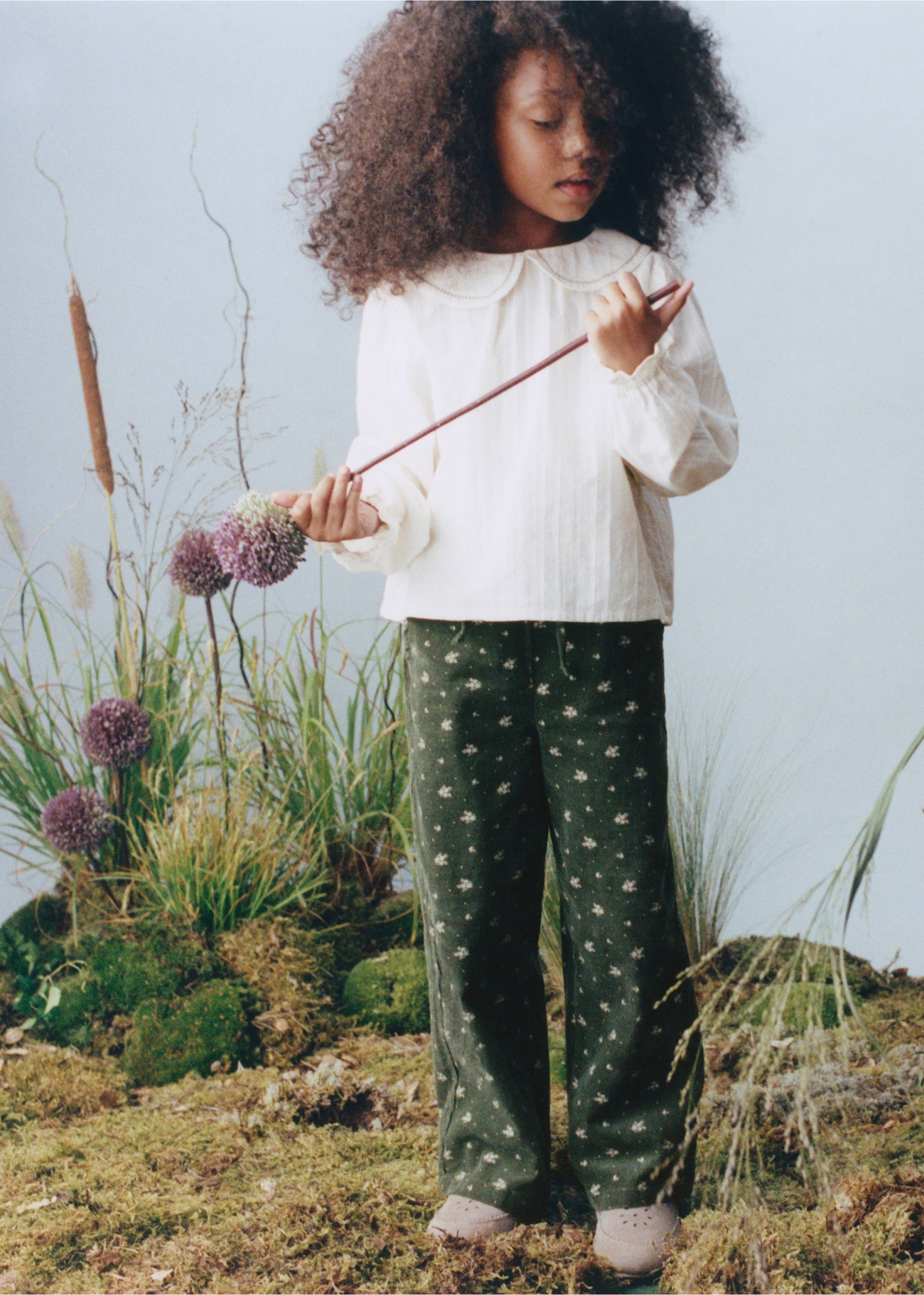 Dark green floral print trousers worn with a cream long-sleeve top., Khaki. Ref: 37077934-00.