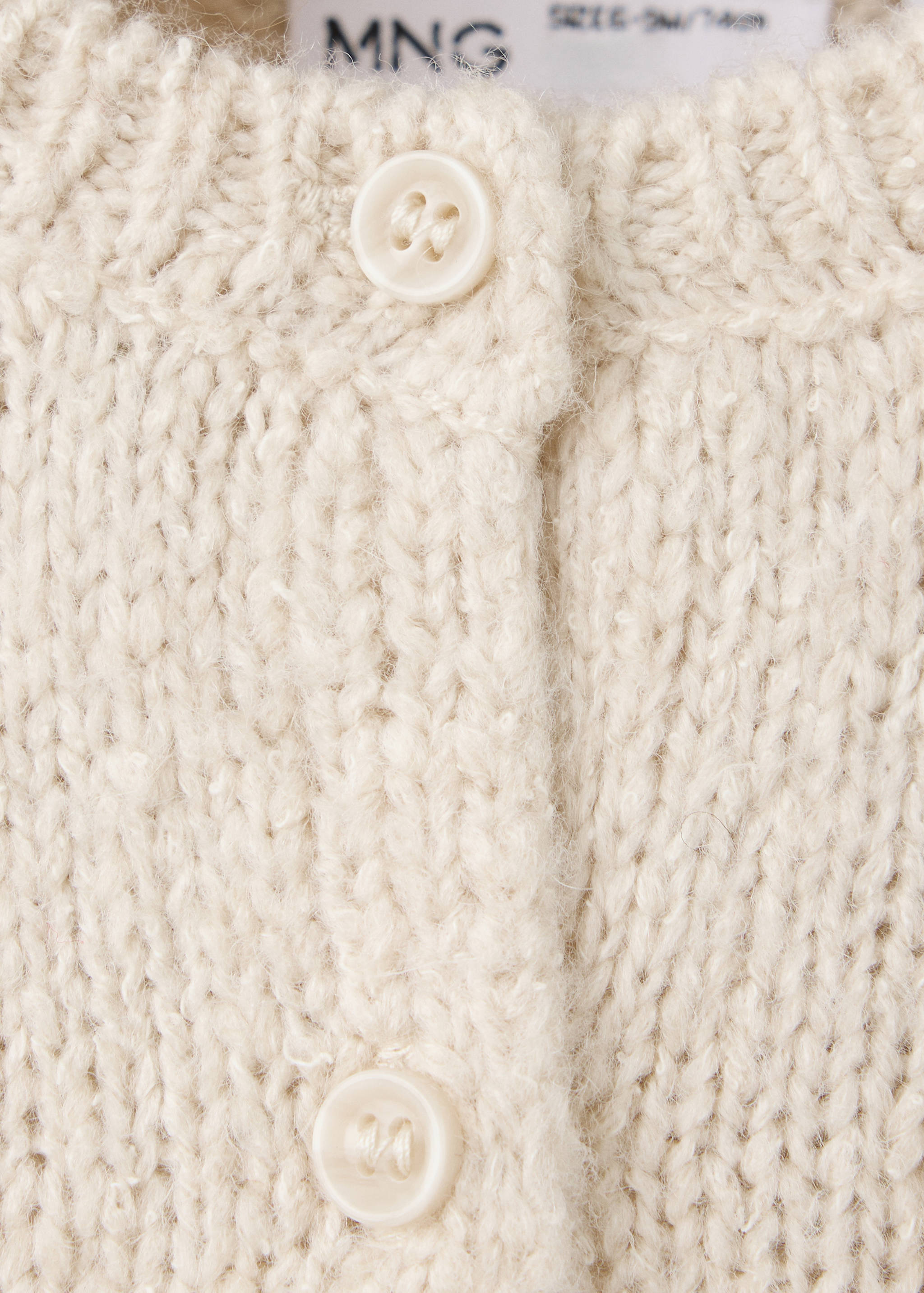 Cardigan detail in a white floral print with red velvet trim.