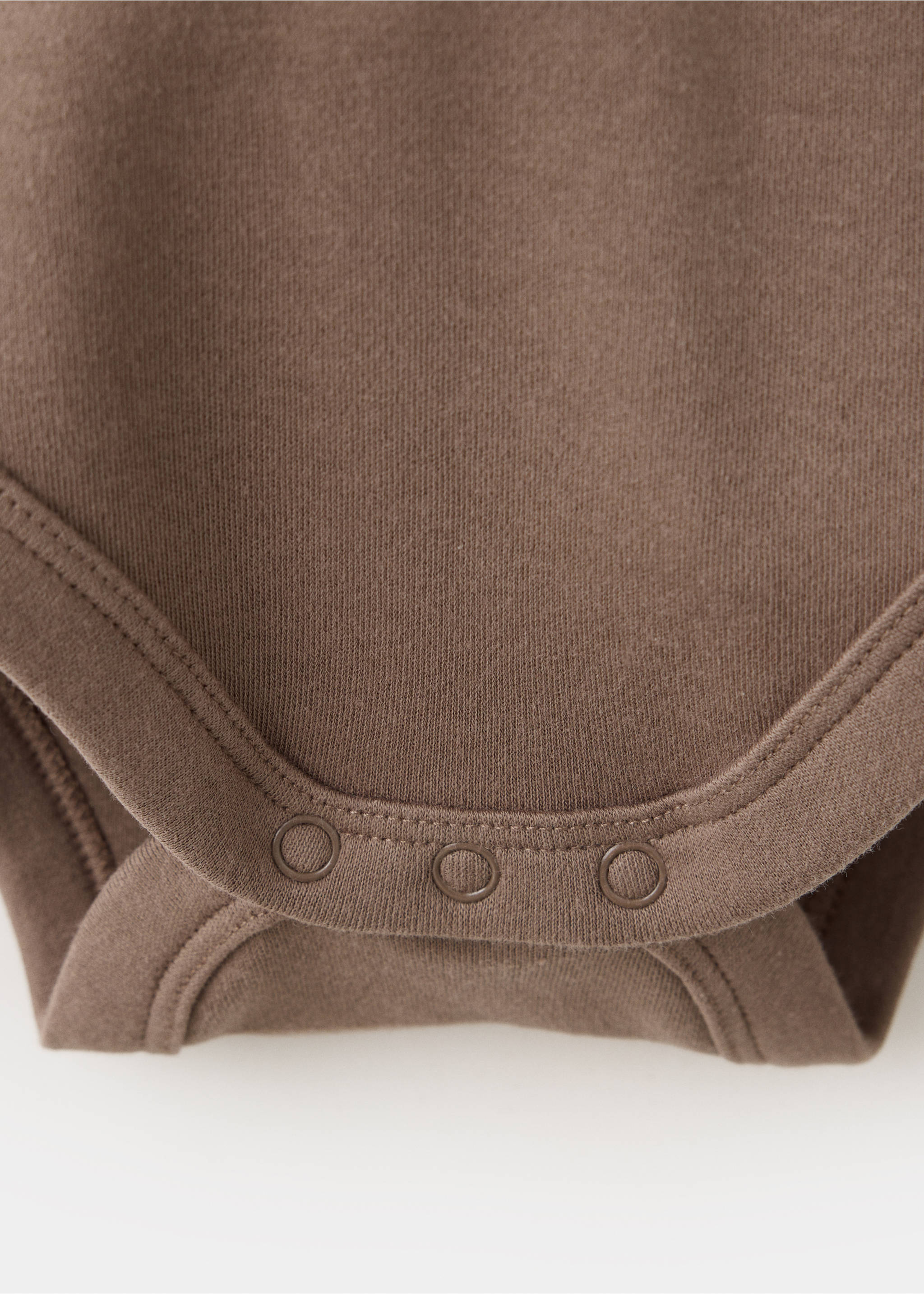 Brown baby body fabric and press stud fastening detail, Chocolate. Ref: 37077936-00.