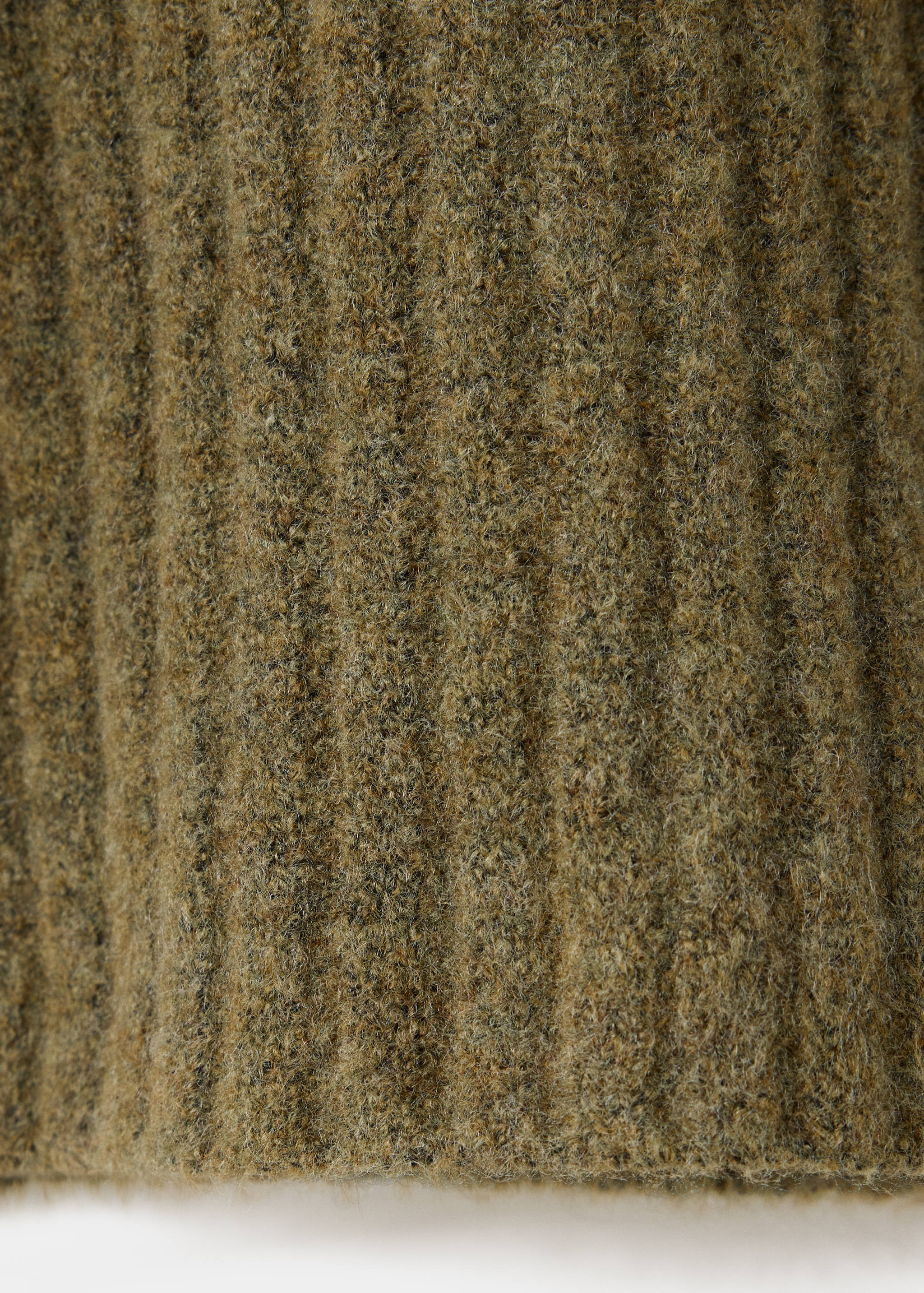 Green knitted kids sweater fabric texture detail with vertical ribs.