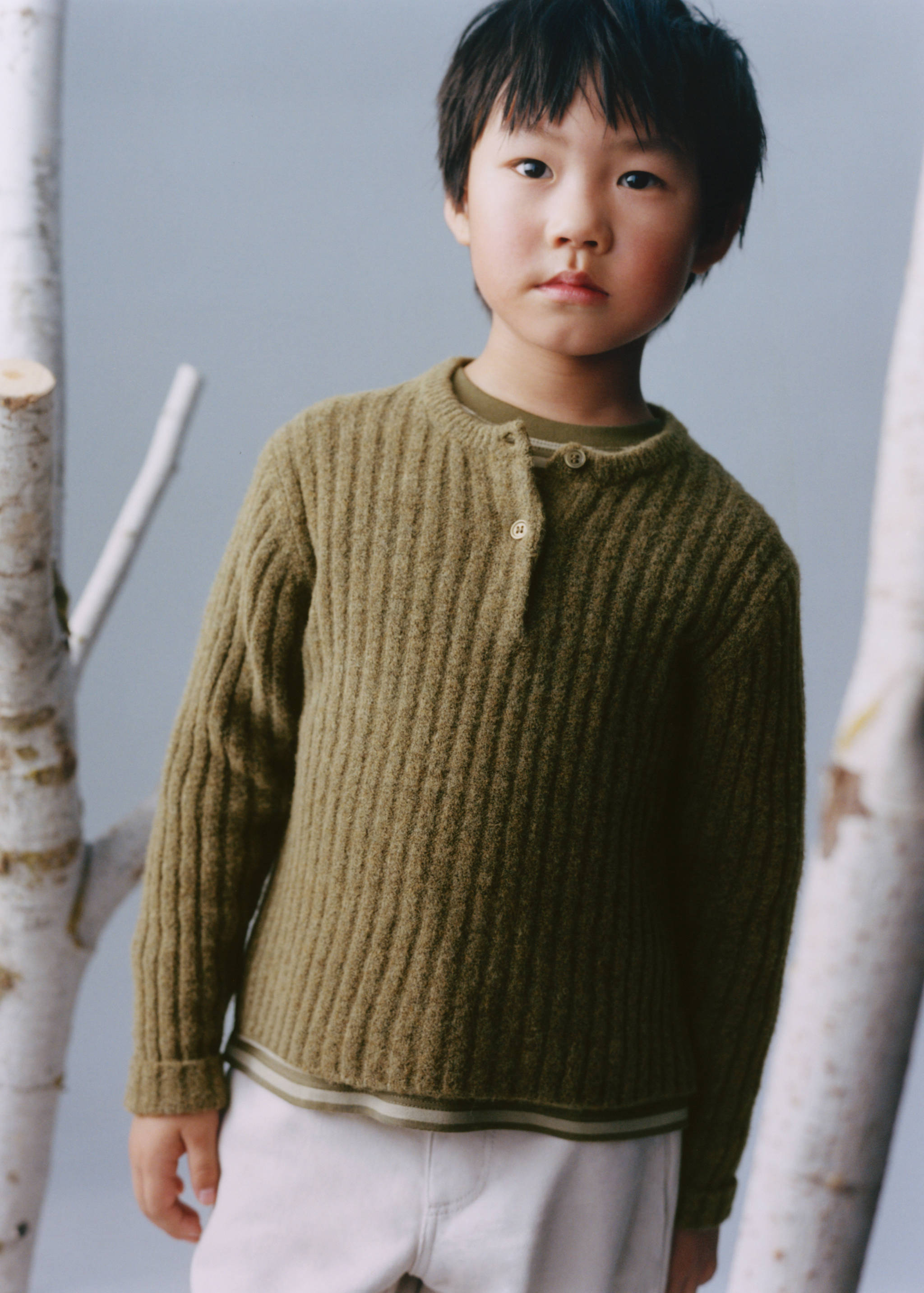 Olive green ribbed knit jersey with a short button placket.