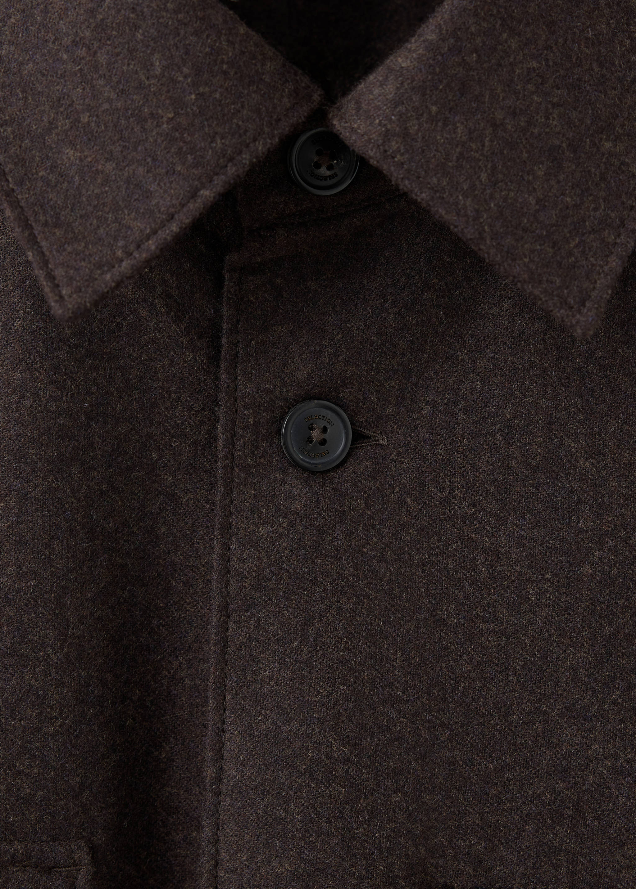 Close-up of a dark brown overshirt collar and button placket.