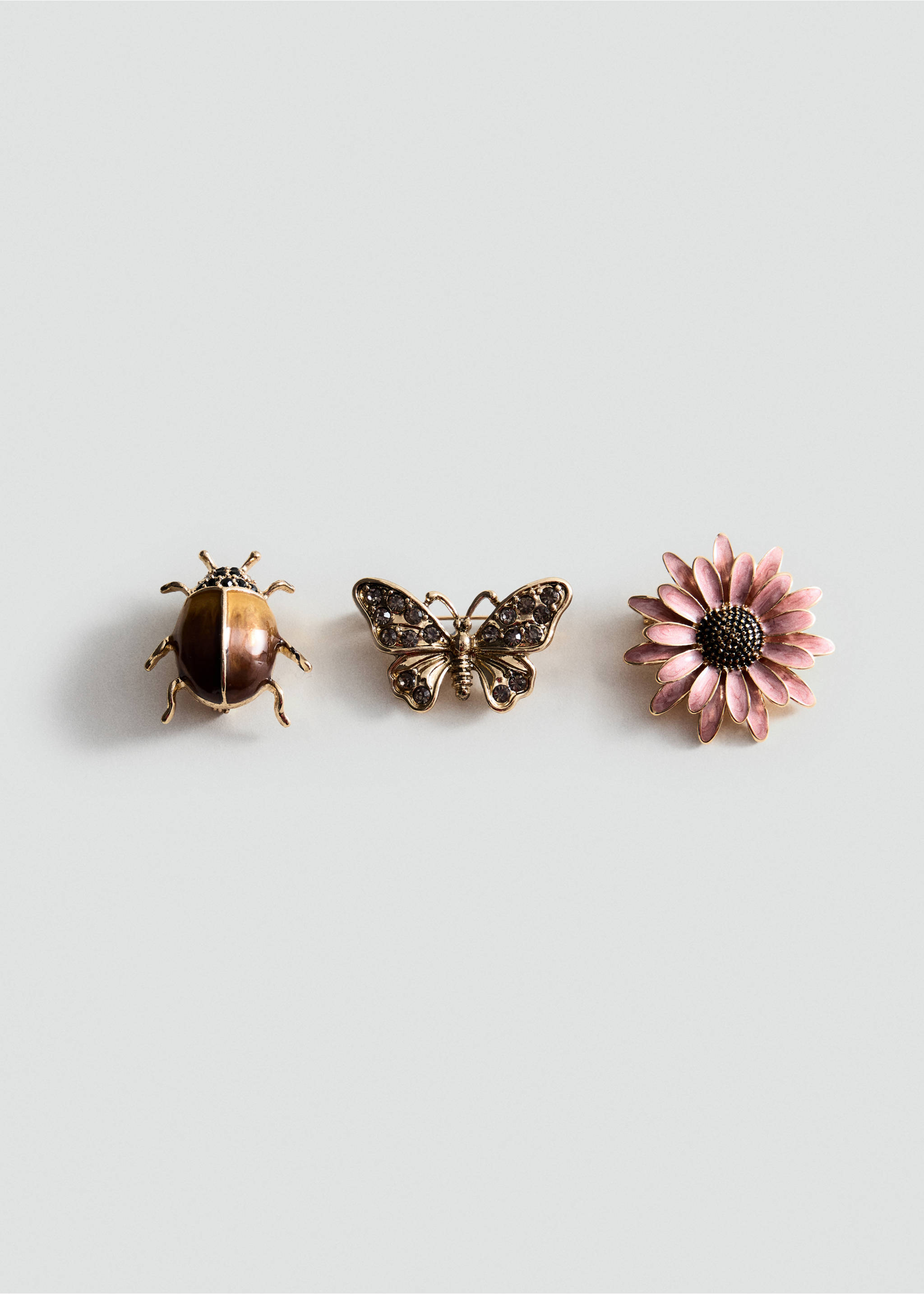 Set of three brooches: a brown beetle, an embellished butterfly, and a pink floral design., Gold. Ref: 37077944-00.