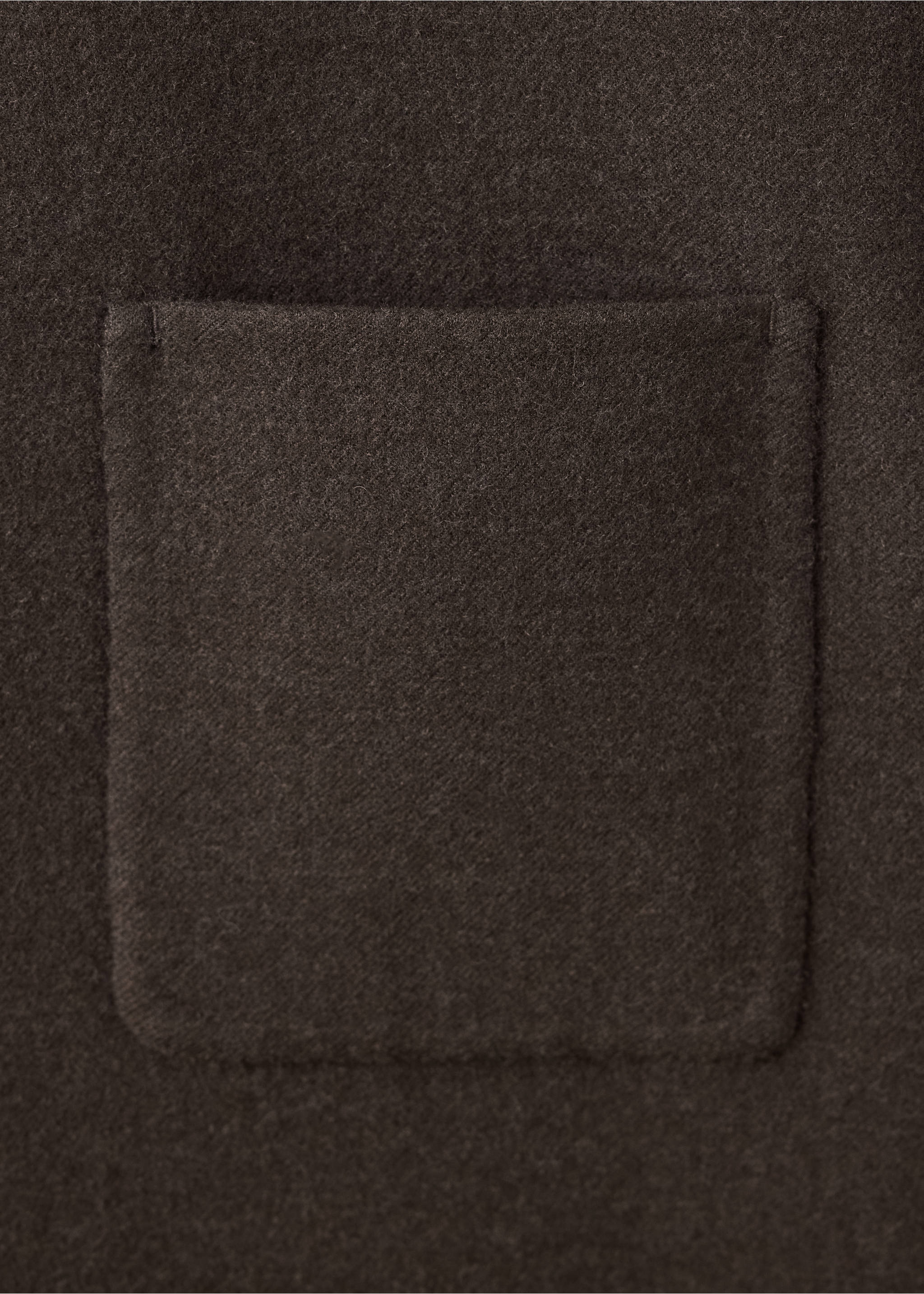 Close-up of the textured fabric and patch pocket on a dark brown blazer., Brown. Ref: 37078266-00.