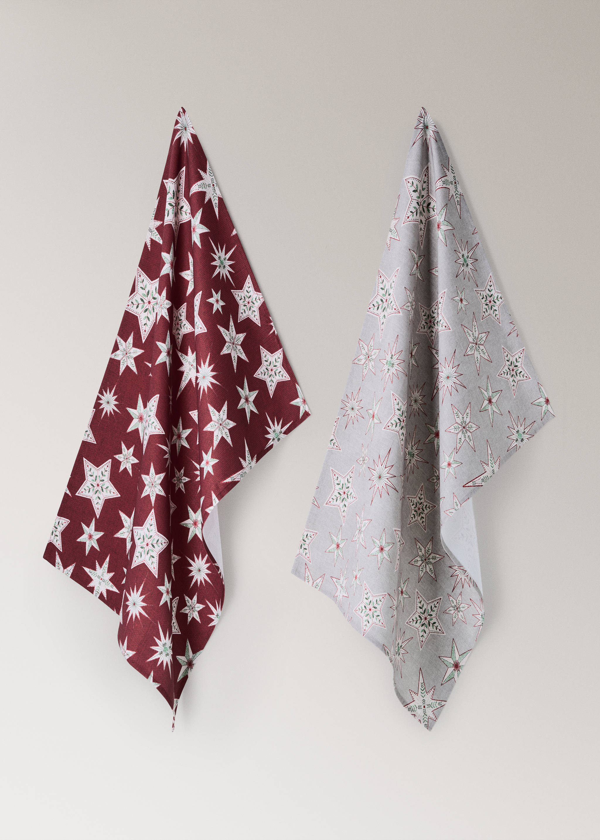 Set of two kitchen towels in red and grey with a festive star pattern.