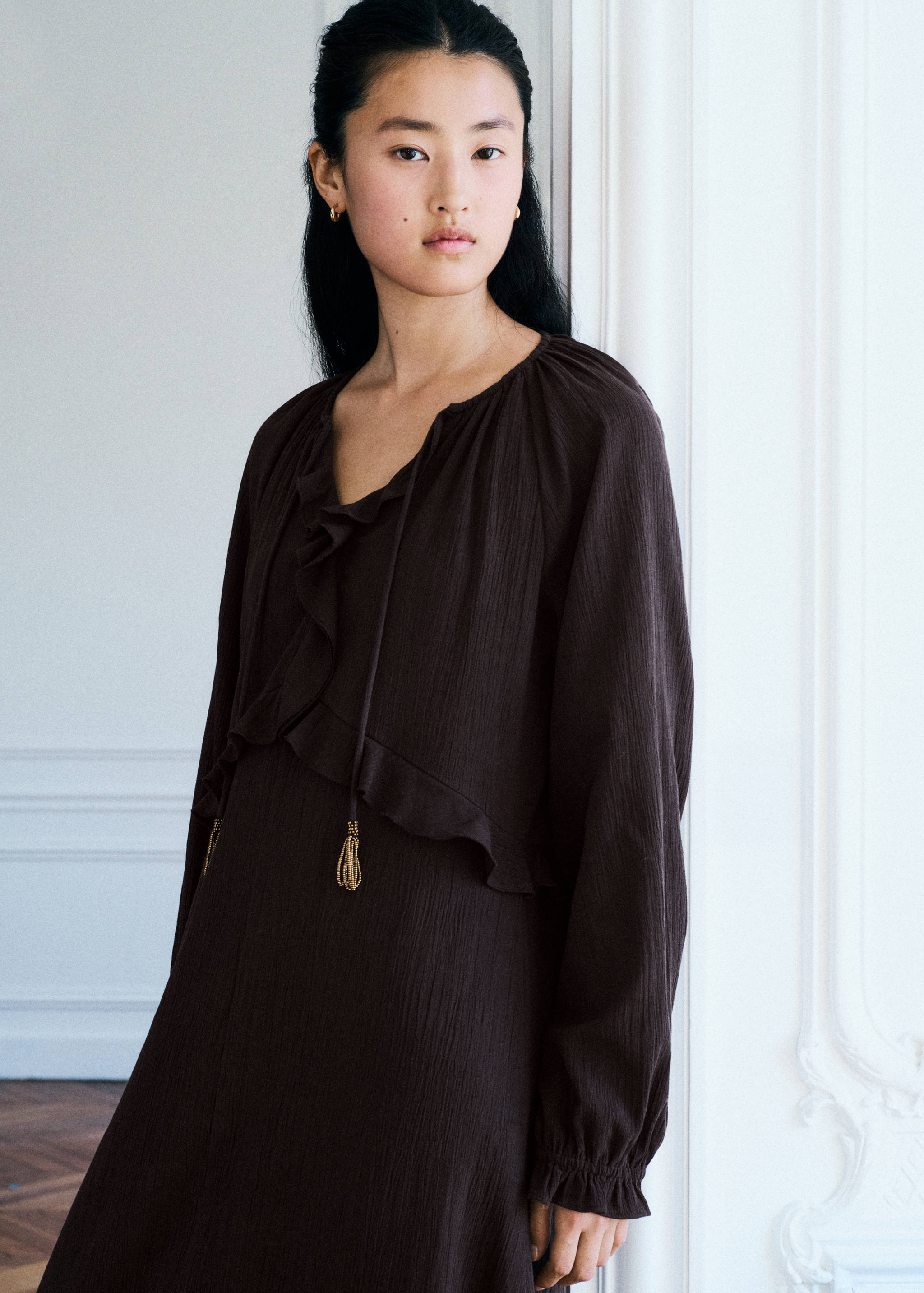 Dark brown textured midi dress with ruffles and tassel ties.