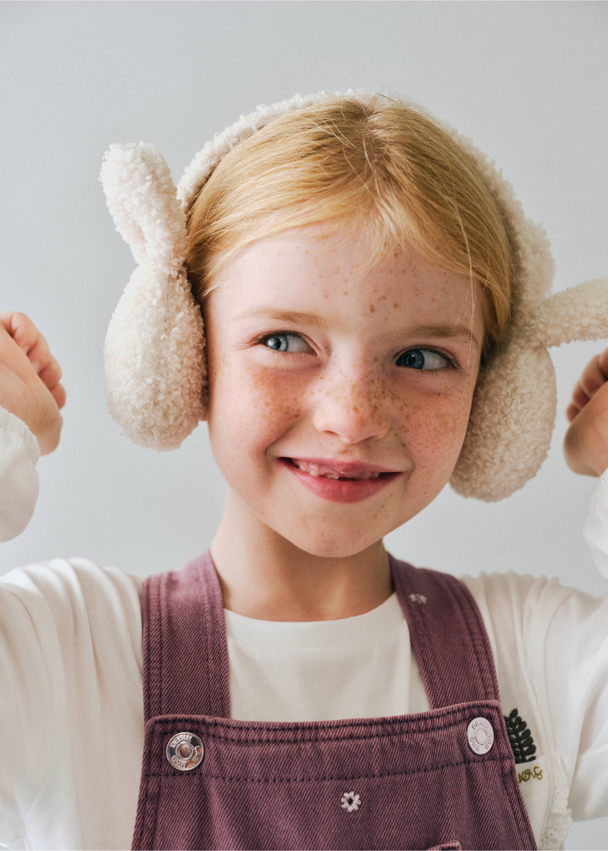Plum corduroy dungarees worn with a white top and cream fuzzy bunny ear earmuffs., Lilac. Ref: 37078285-00.