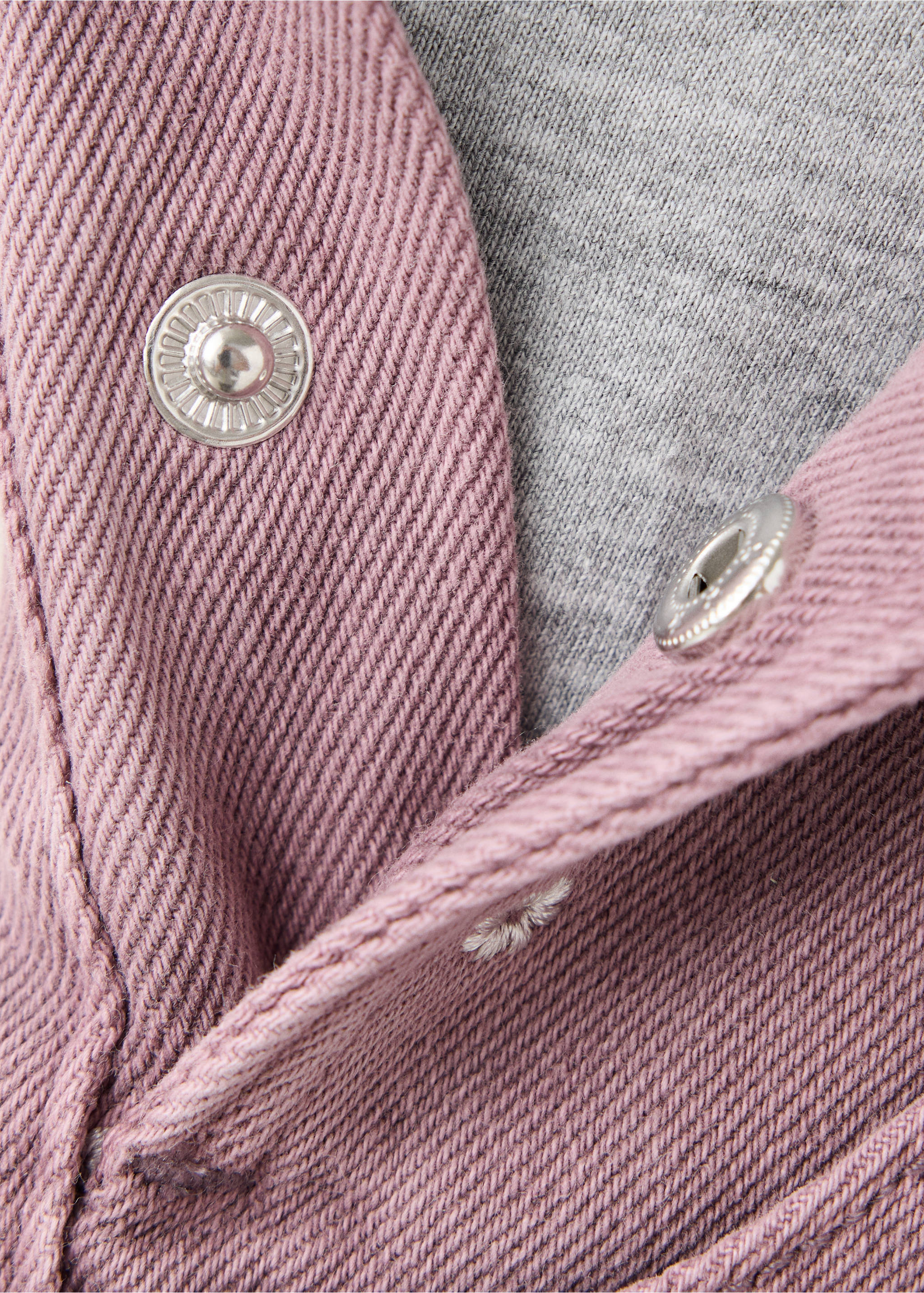 Pink denim dungaree fabric detail showing metal snap buttons., Lilac. Ref: 37078285-00.