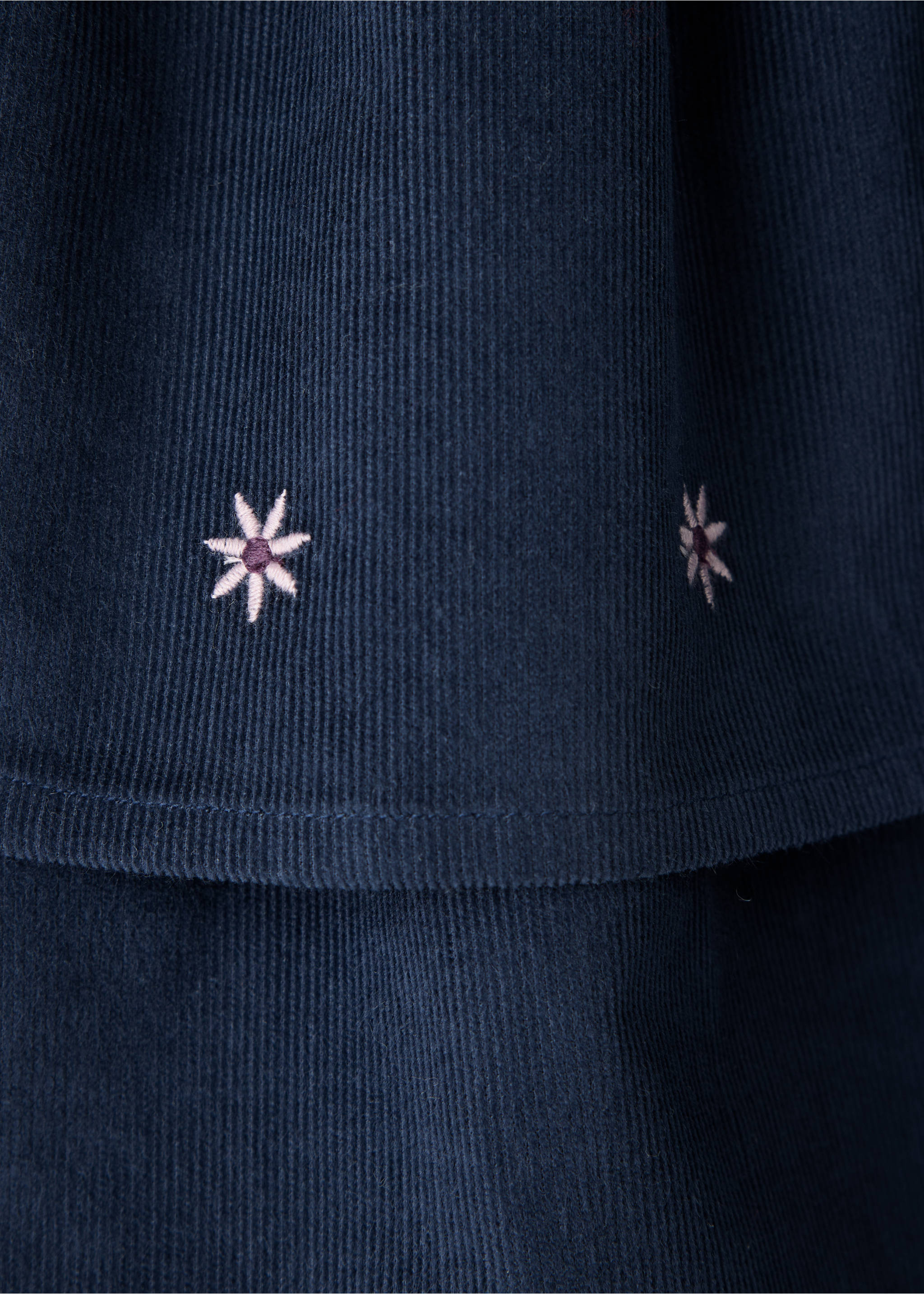 Navy blue corduroy skirt fabric detail with embroidered floral motifs., Navy. Ref: 37078286-00.