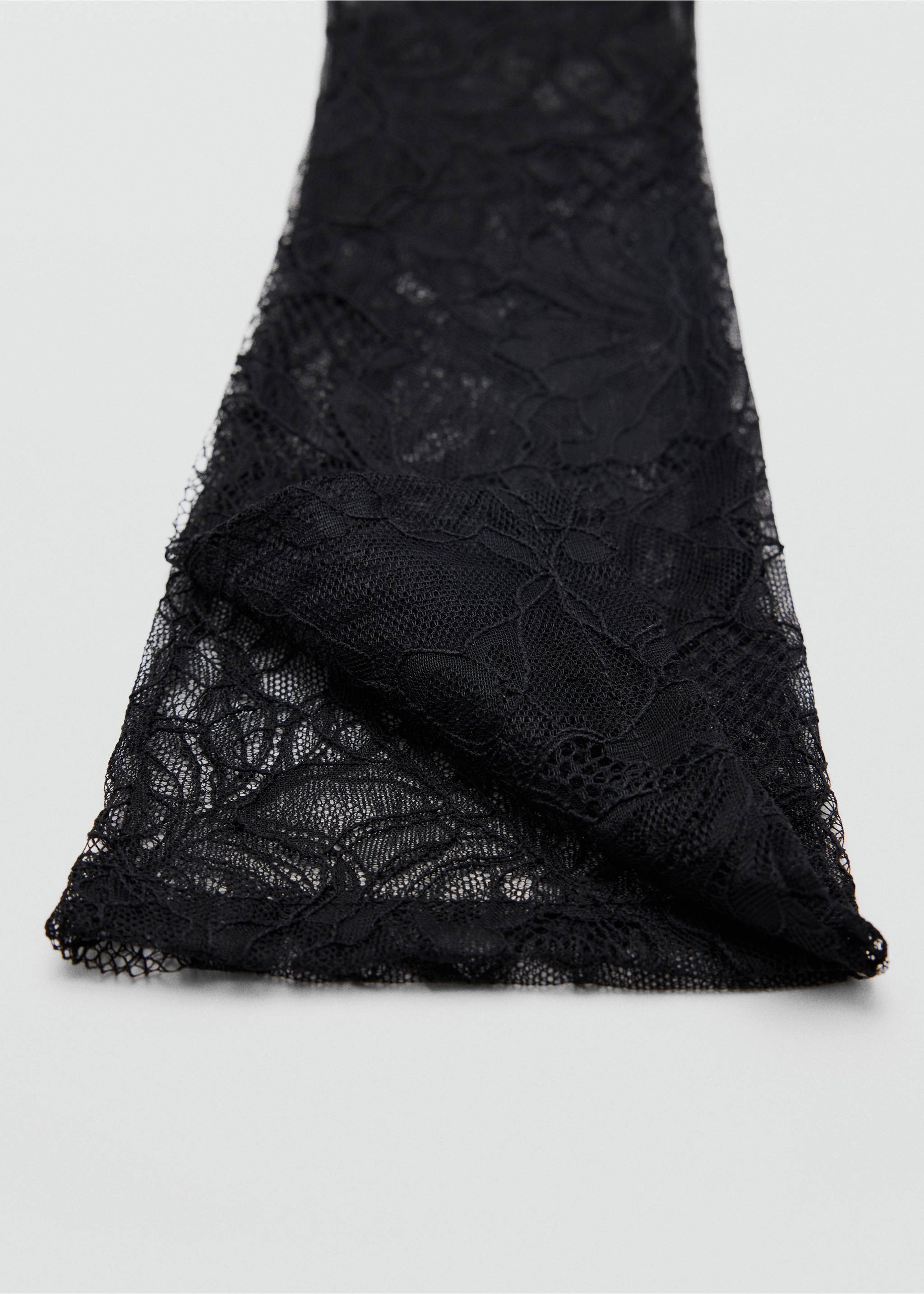 Close-up of black lace gloves featuring intricate floral patterns., Black. Ref: 37078632-00.