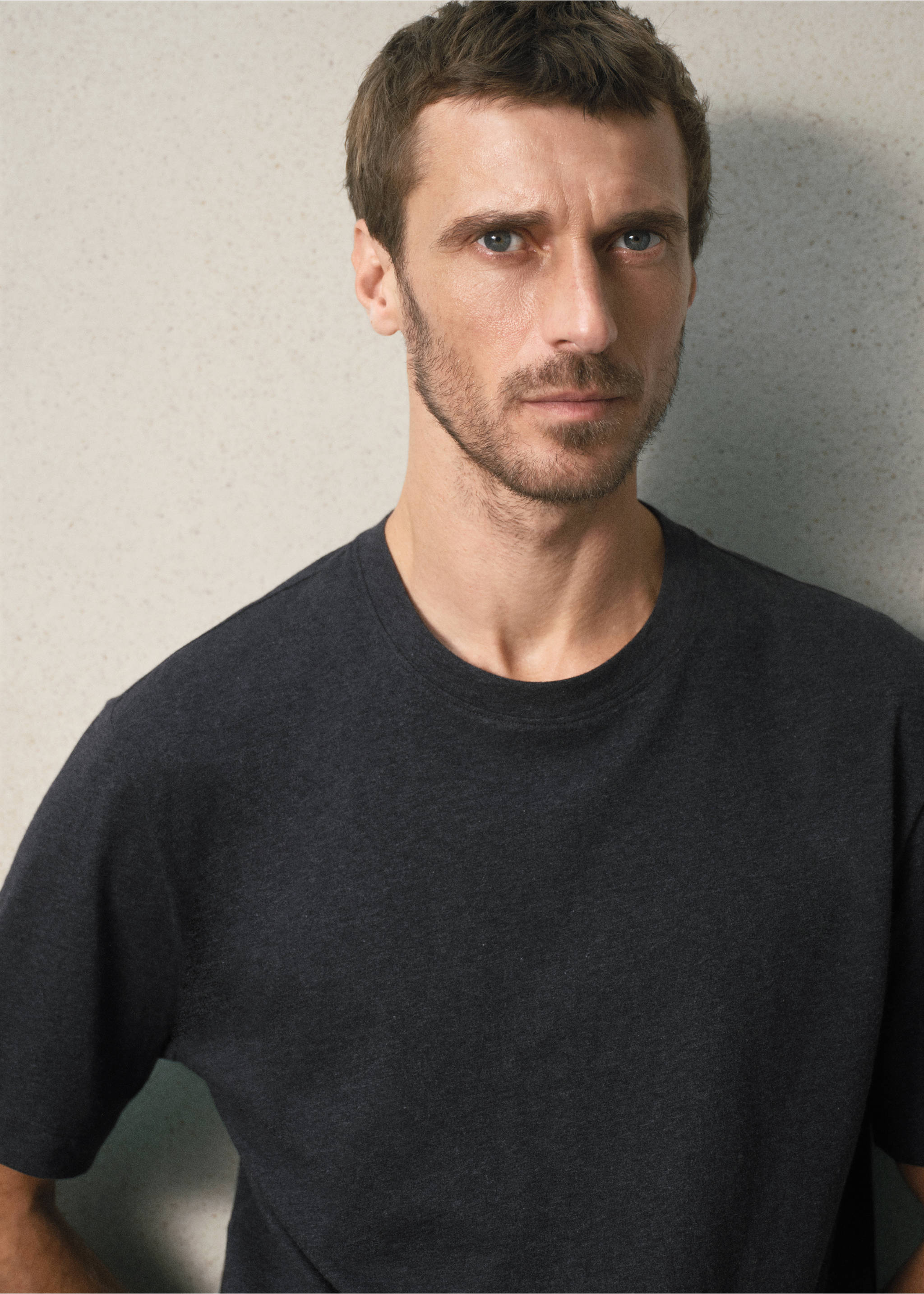Dark grey crew neck t-shirt shown in a close-up portrait., Charcoal. Ref: 37078635-00.