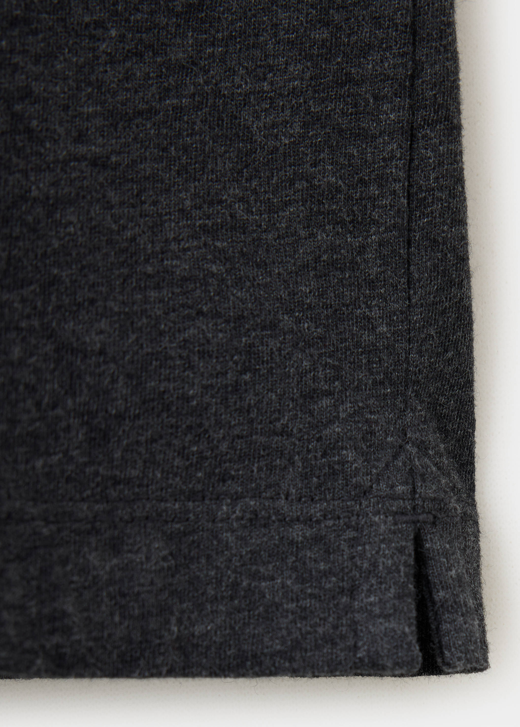 Close-up of the dark grey fabric texture of a t-shirt.