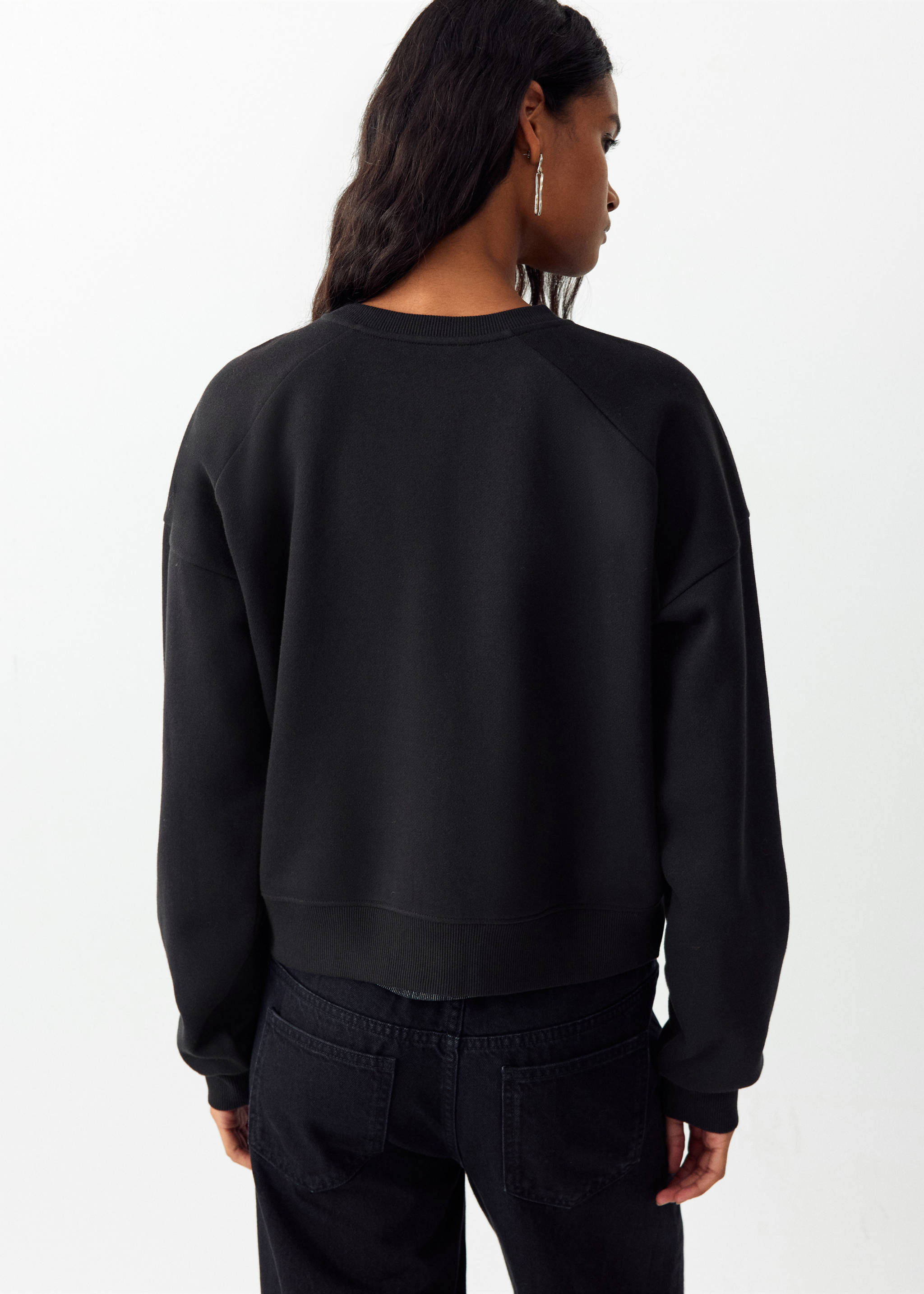 Black sweatshirt with a crew neck and raglan sleeves, back view