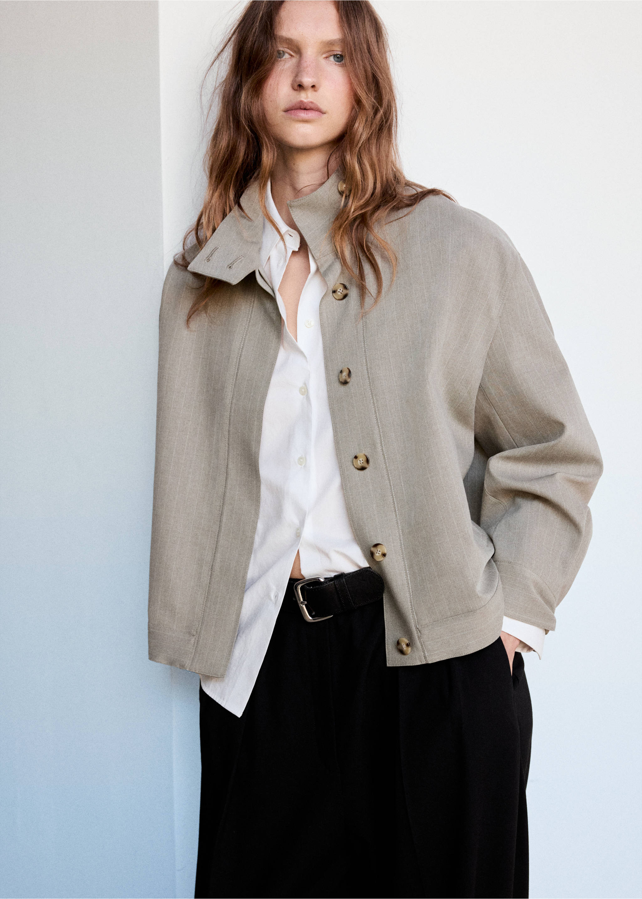 Grey-green structured jacket with high collar and tortoiseshell buttons worn over a white shirt., Medium Brown. Ref: 37078639-00.